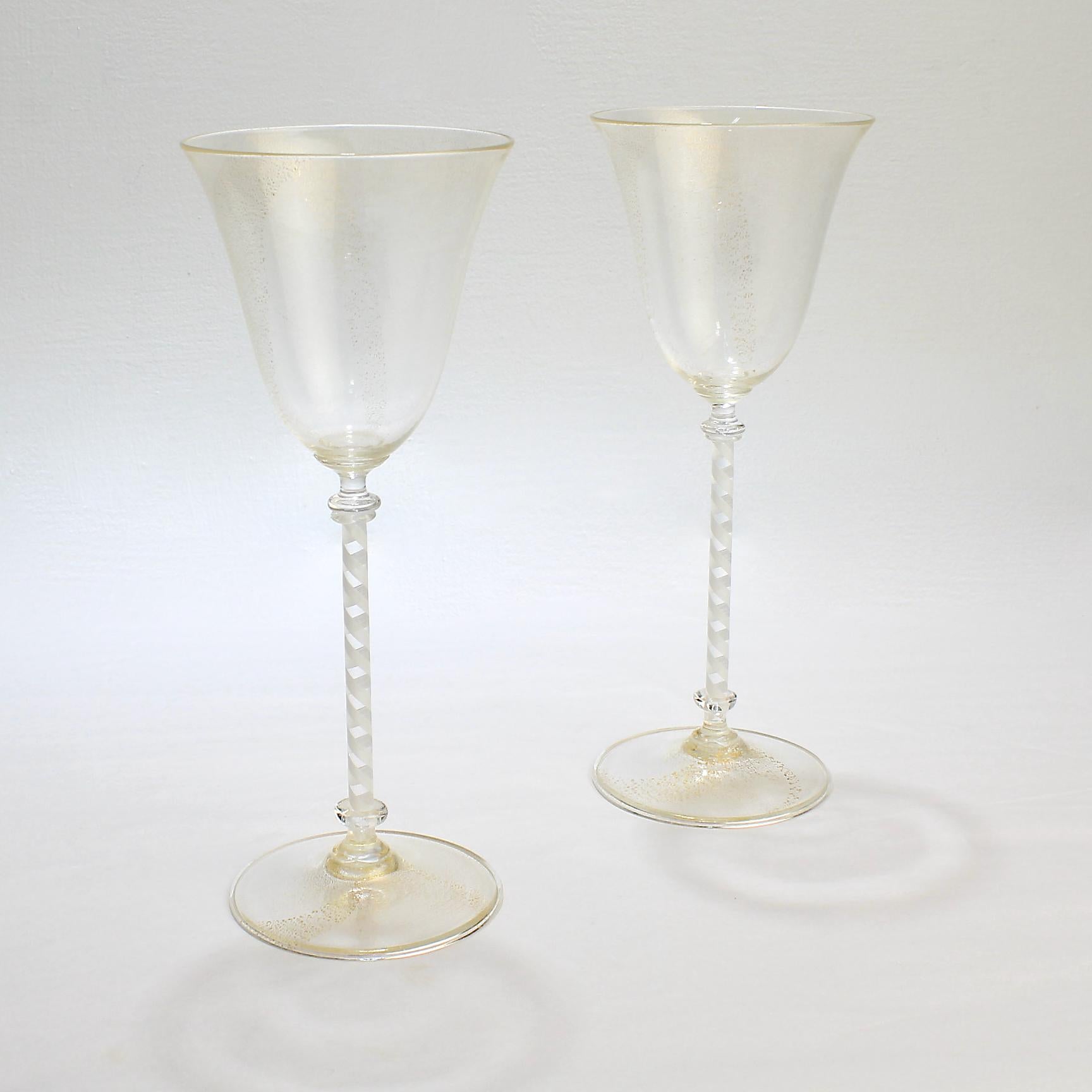 A very fine pair of vintage Venetian or Murano glass wine goblets.

Attributed to Salviati. 

The bowls and feet have gold inclusions, and the stem is built on a twisted white filigrana cane. 

Simple and refined wine stems that are perfect
