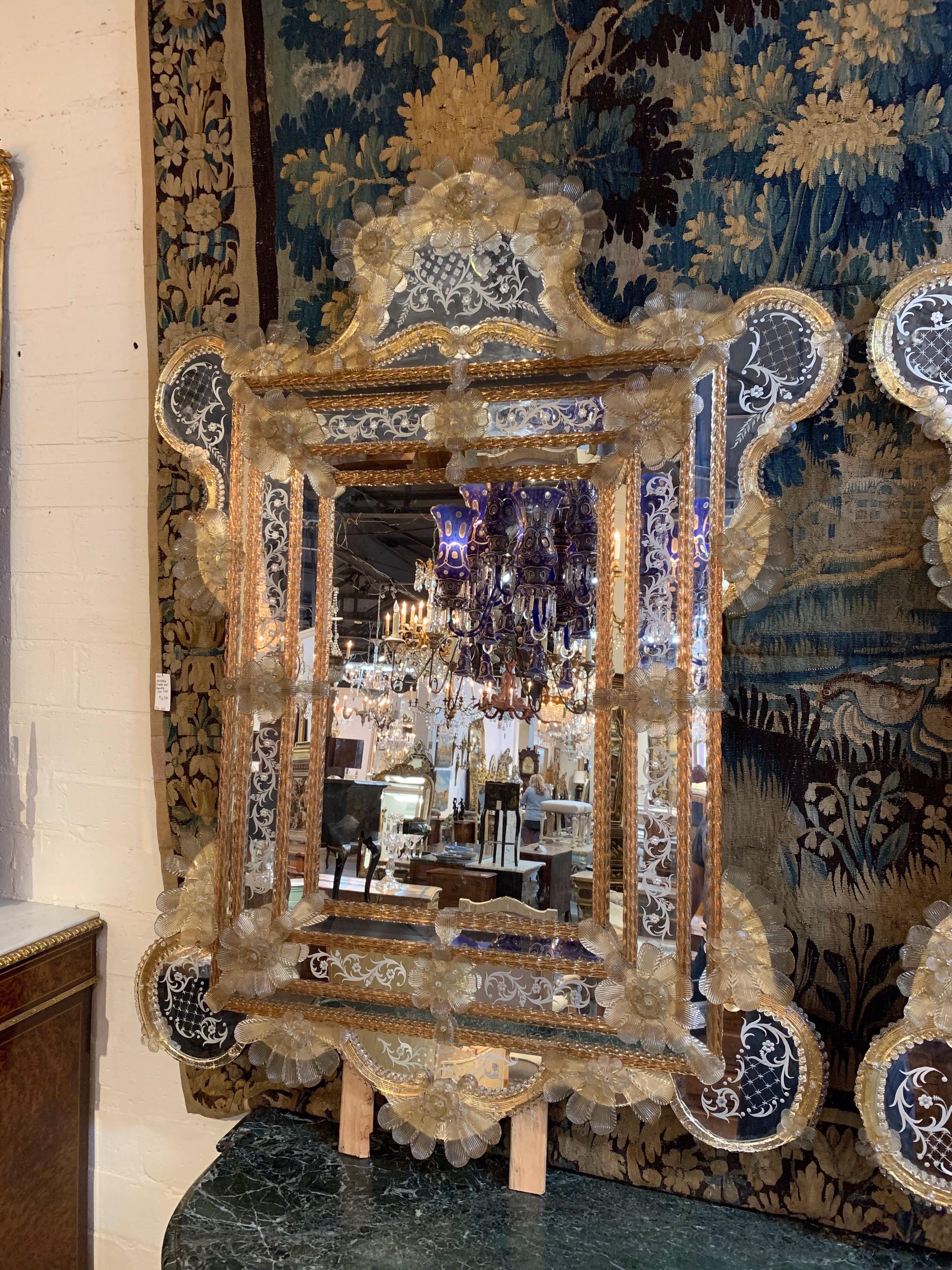 Fabulous pair of Venetian gold etched mirrors. There are gold flowers around the border of the mirrors and beautiful etching. These are gorgeous and really make a statement. The price listed is per item. Also, please note there are a few missing