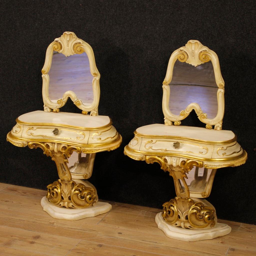 Pair of Venetian bedside tables from the mid-20th century. Furniture in richly carved, lacquered and gilded wood of fabulous decor. Bedside tables with mirrors built in a single non-divisible body, ideal for a bedroom. Furniture fitted with a