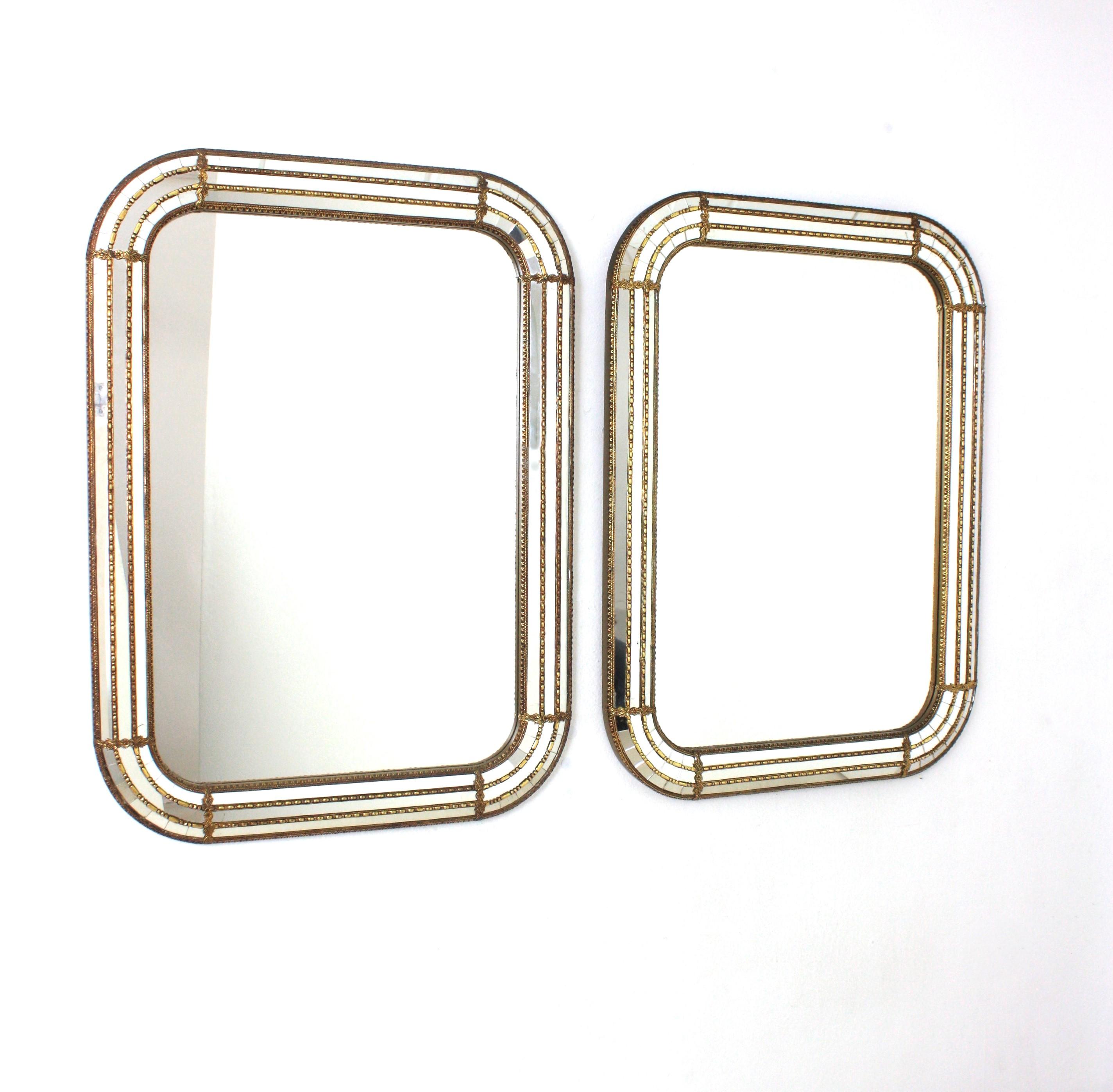 Pair of Venetian style rectangular wall mirrors with round corners and gilt metal accents, Spain, 1960s
This pair of wall mirrors have a triple mirror frame with rectangular shape and rounded corners. The central layer is made of mirror glass and