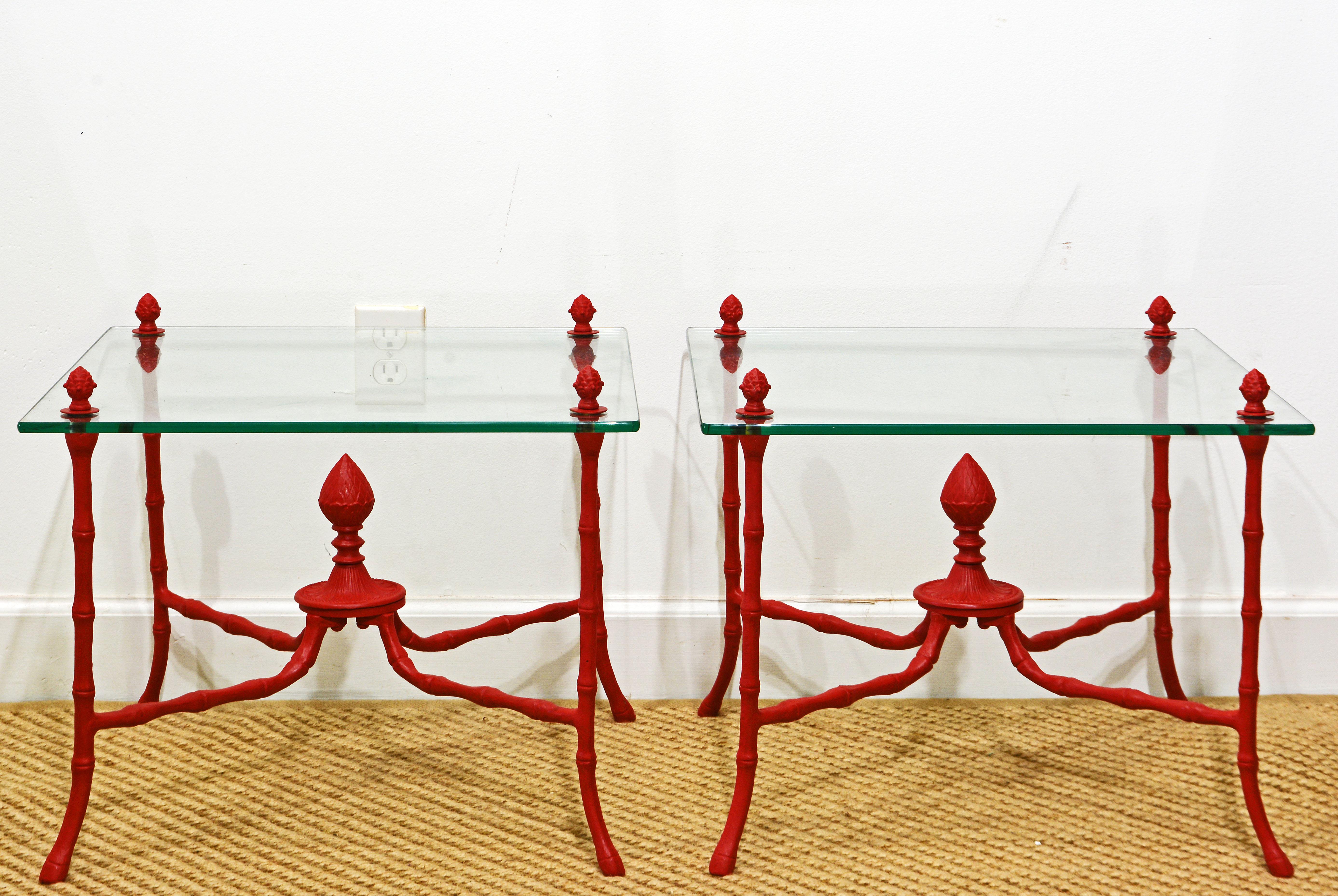 These elegant Italian Venetian Red Regency Style faux bamboo side tables or end tables feature lacquered and hand buffed metal frames supporting the floating glass tops with corner joints topped by acorn style fiials. The frames are handmade