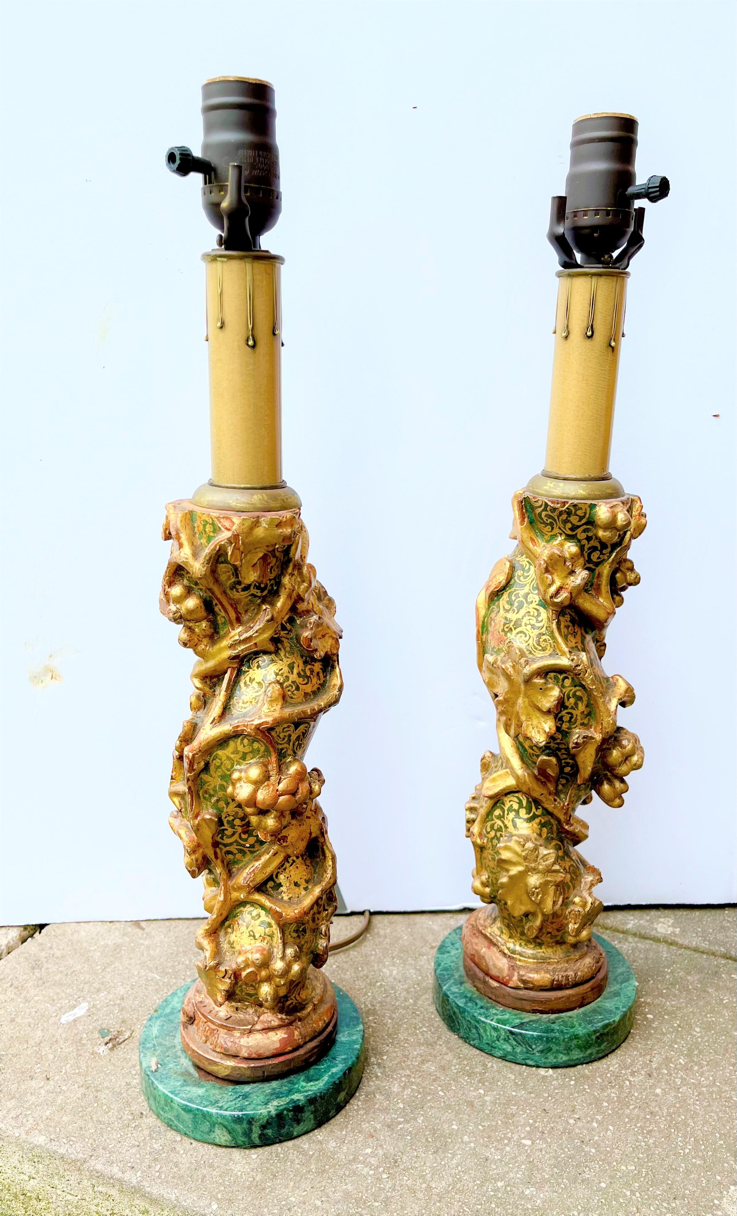 Pair of Venetian (Italian) Solomonic form columnar fragments (probably stair spindles ) now mounted as lamps on later marble bases . Typical grape & vine motif against an unusual green and gilt ground in glossy enamel paint .Typical chips , losses