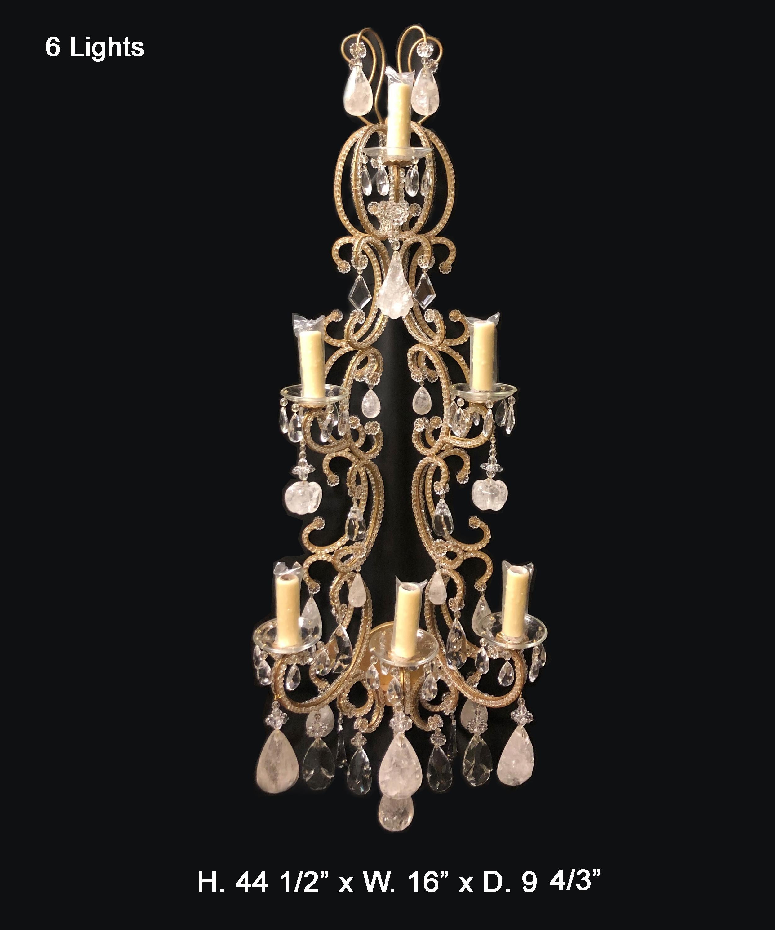 Gorgeous and large pair of Venetian style rock crystal and lead crystal six light sconce. Antique gold finish.
The sconce is beaded with faceted lead crystal beads and rosettes throughout, issuing six scrolling arms with an electrified candleholder