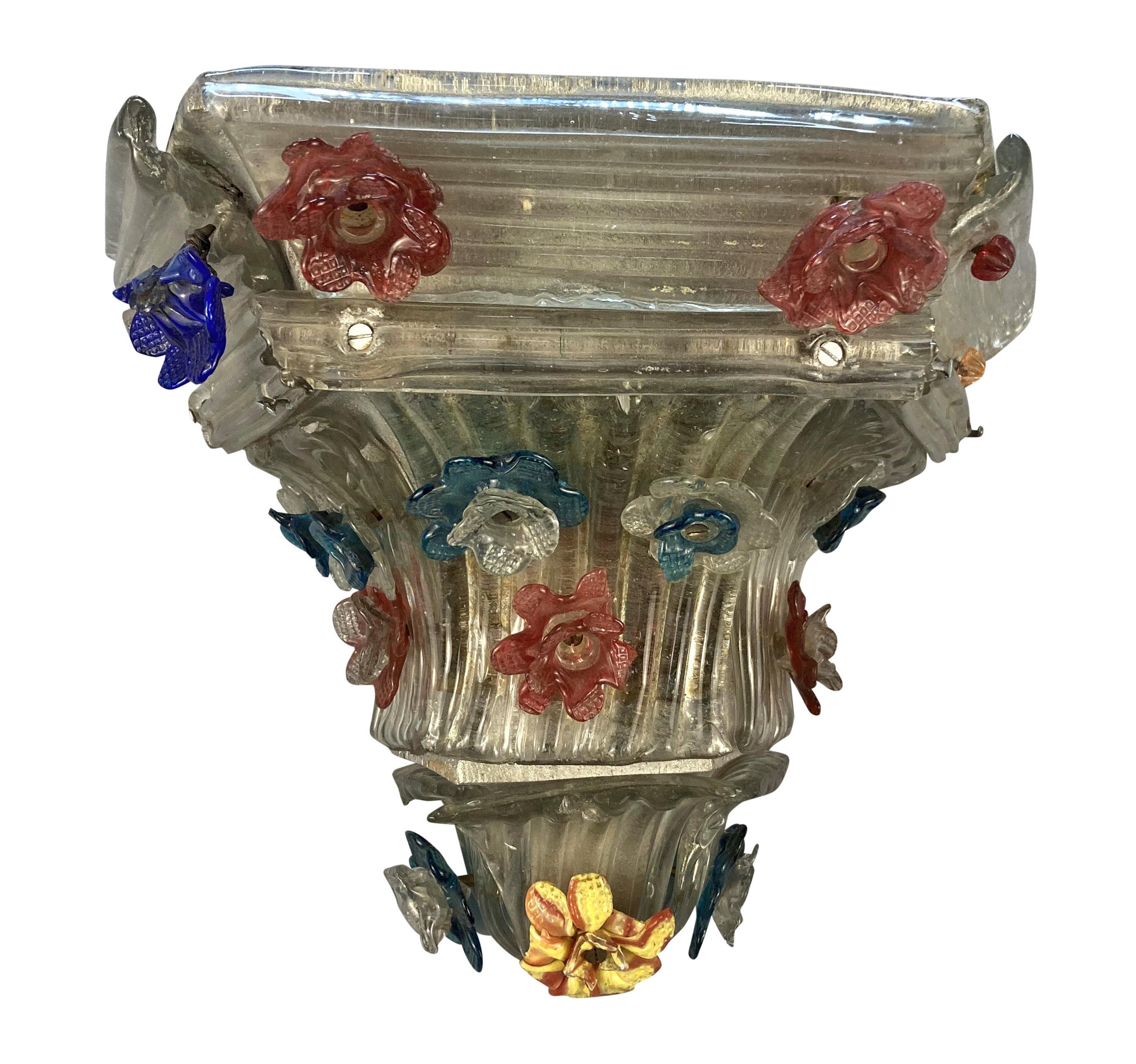 A pair of Venetian wall brackets in hand blown glass, with floral designs. Some losses.