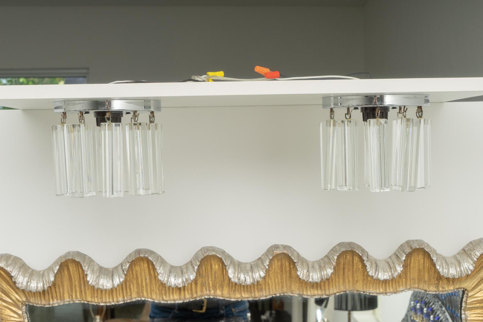 This stylish petit pair of Venini, Murano glass and chrome flush-mount chandeliers date to the 1970s and are the perfect scale for a powder-room, entry and could be used down a hallway.

Note: Requires one Edison based bulb each.