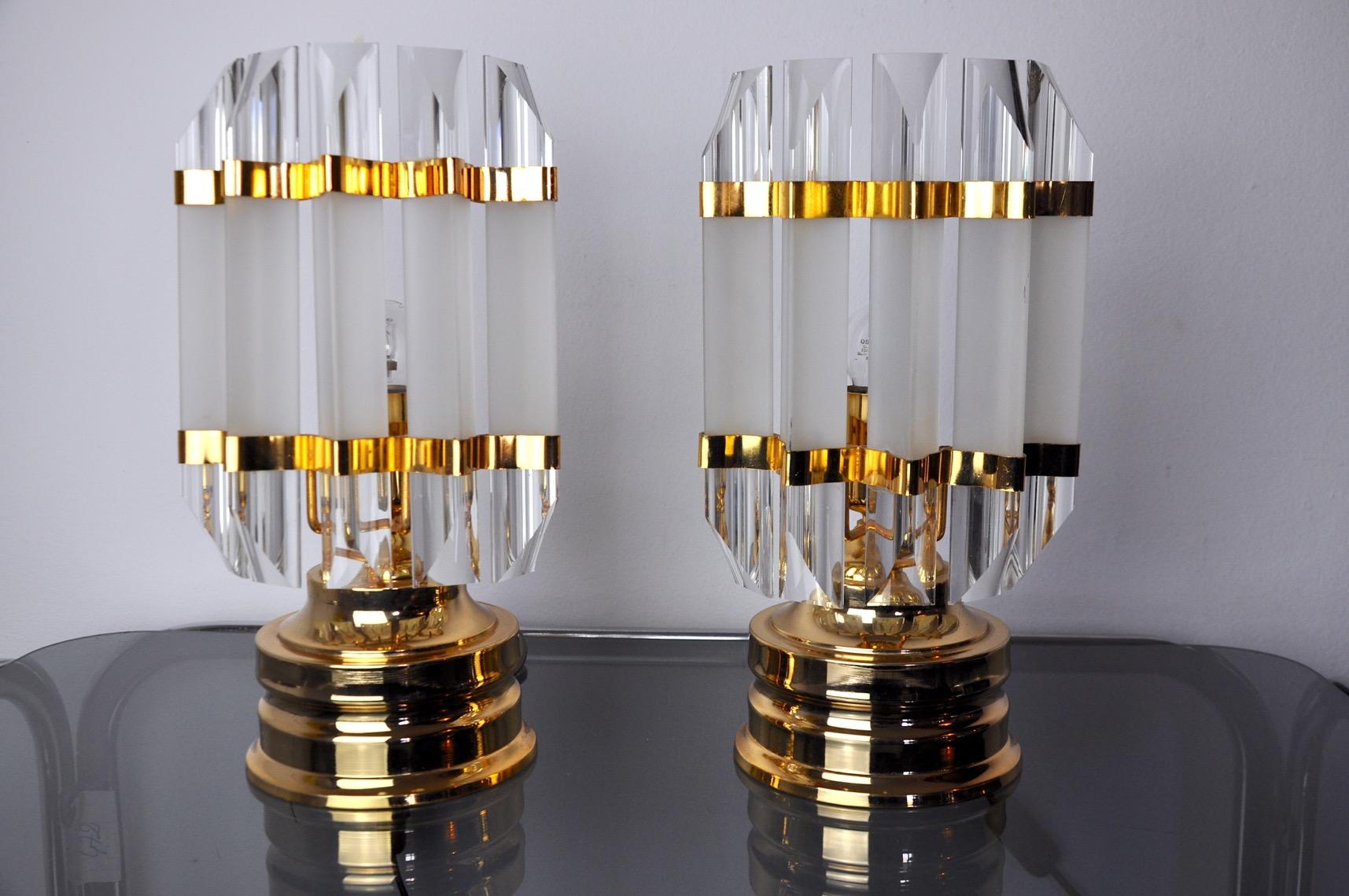 Very nice pair of venini lamps produced in italy in the 70s. Golden metal structure and cut glass. Unique objects that will illuminate marvelously and bring a real design touch to your interior. Electricity checked, mark of time relating to the age