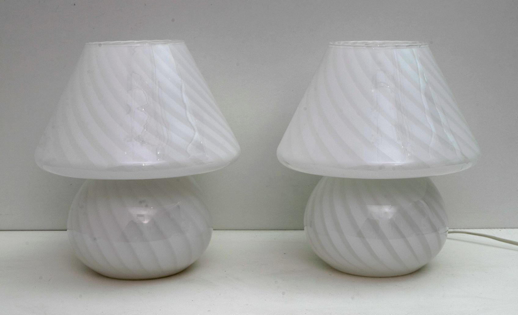 This pair of Murano glass mushroom lamps were produced by Venini in the 1970s.

For over ninety years the Venini brand has been characterized by craftsmanship and tradition in the international glass objects market. The first artistic director