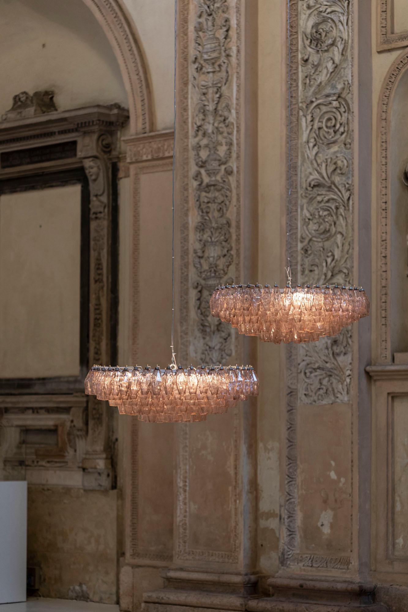 Pair of Venini poliedri chandeliers in extraordinary dimensions and conditions.
Midcentury chandelier by Venini made with their iconic pink hand blown Murano glasses and white lacquered iron structure.
     