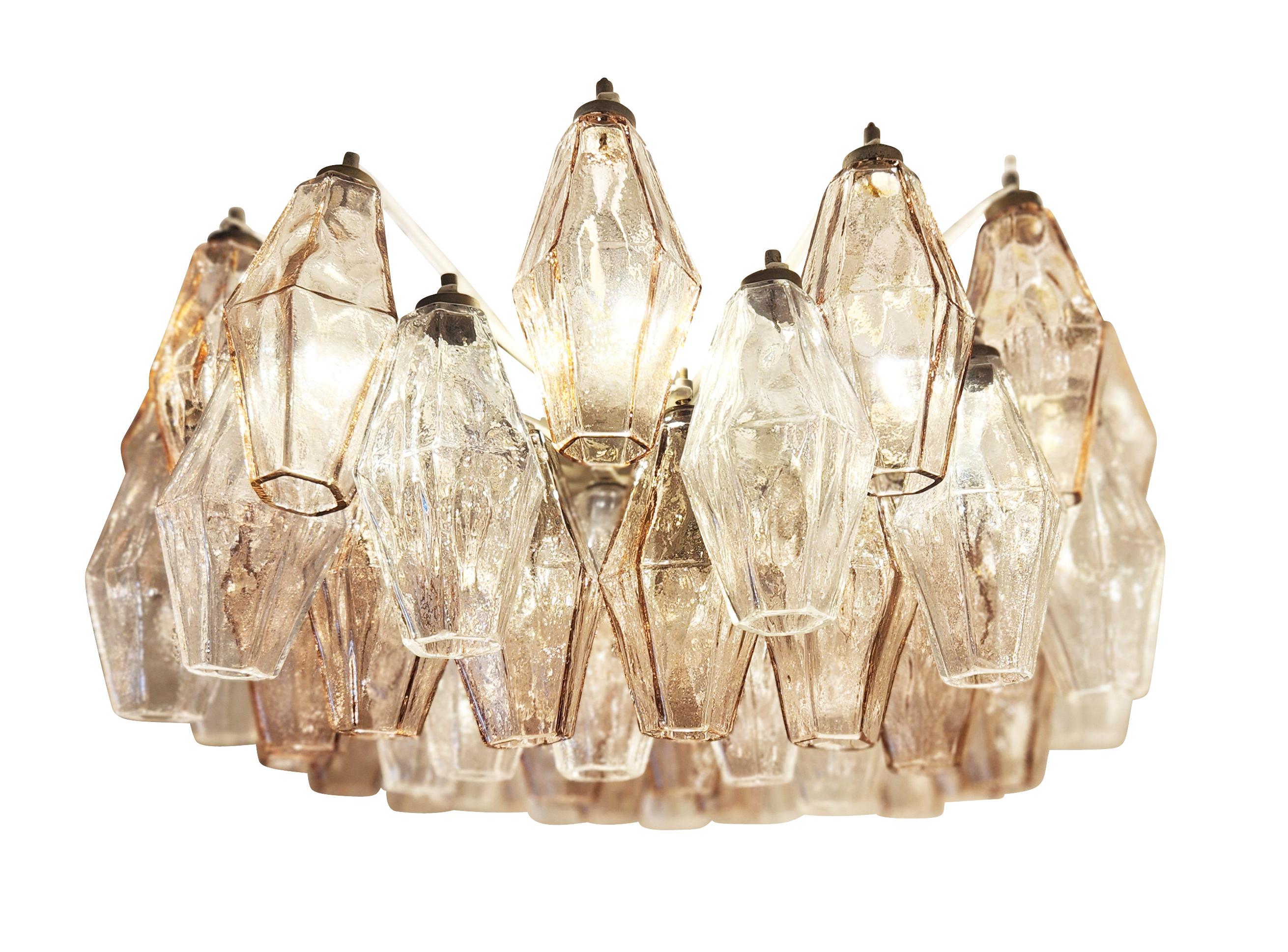 Mid-century chandeliers by Venini made with their iconic poliedri Murano glasses. The glasses are a mix of light rose and clear mounted on a white lacquered frame holding seven E12 candelabra bulbs each. Ready to hang on a chain. Price per