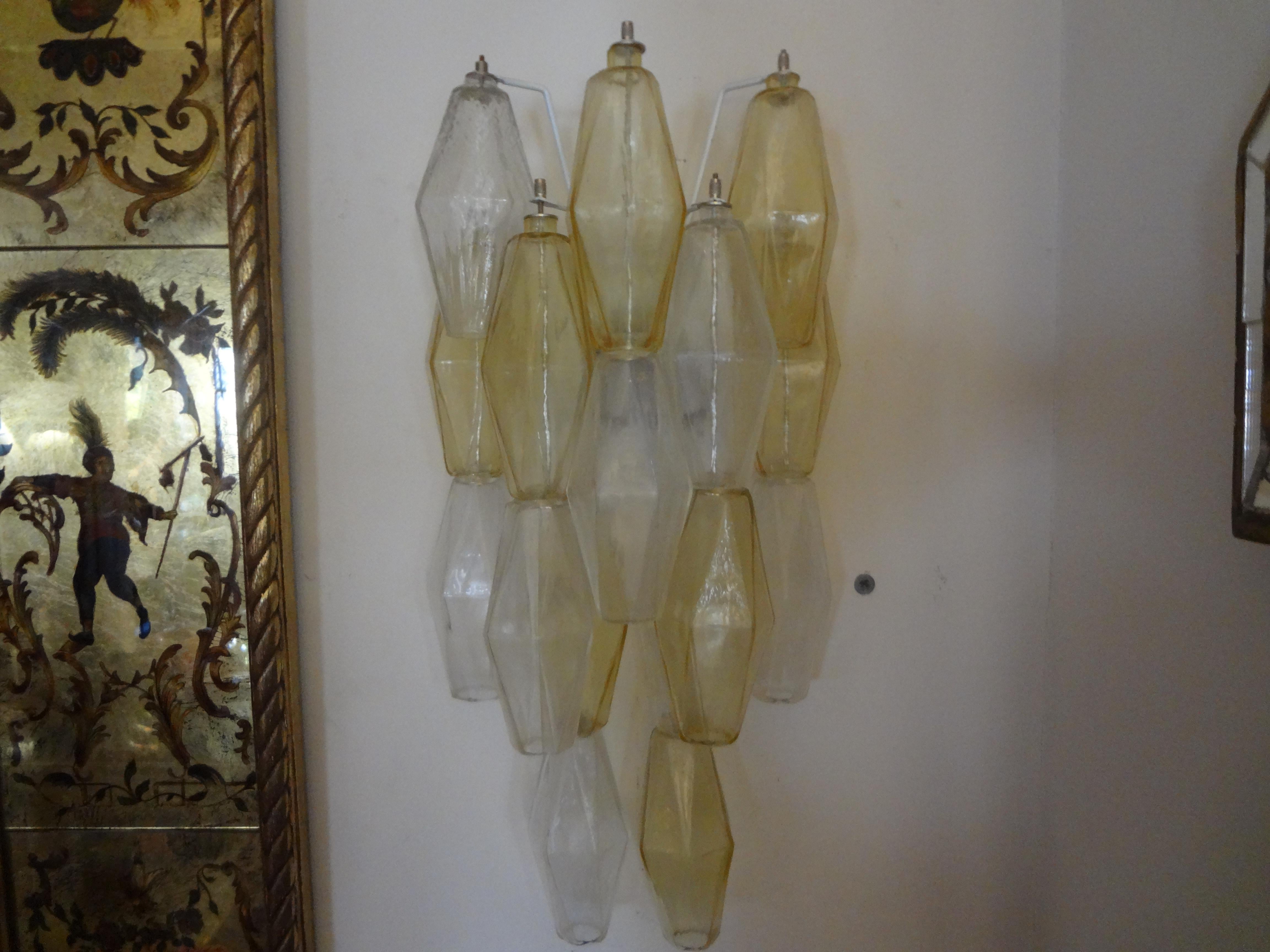 Great pair of Italian Venini style clear and yellow Murano glass polyhedron sconces. This pair of Mid-Century Modern polyhedral Murano glass sconces have been newly wired. These Murano blown glass wall lights are versatile enough to be used in a