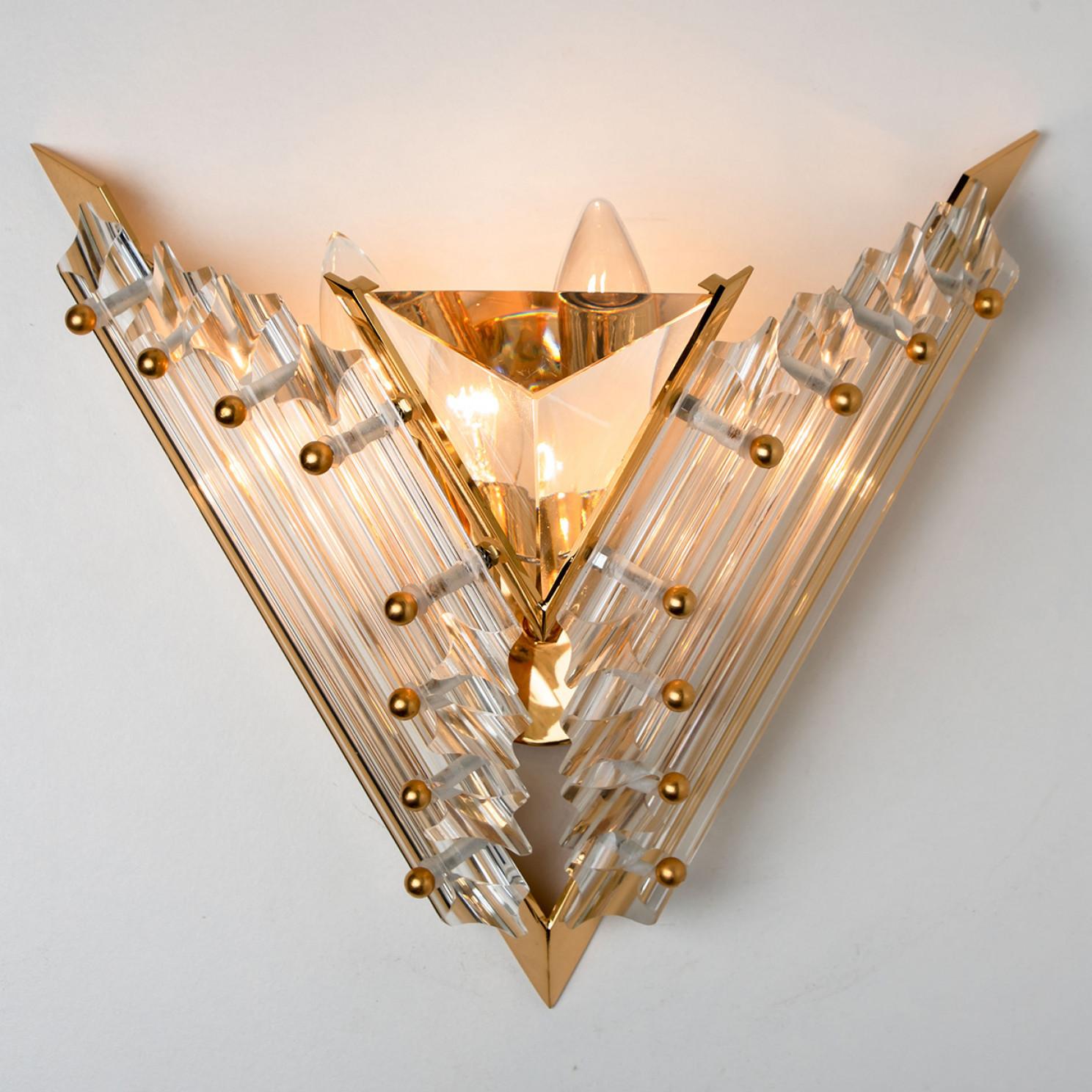 Beautiful triangle shaped glass wall sconces featuring eight long crystal clear glass 