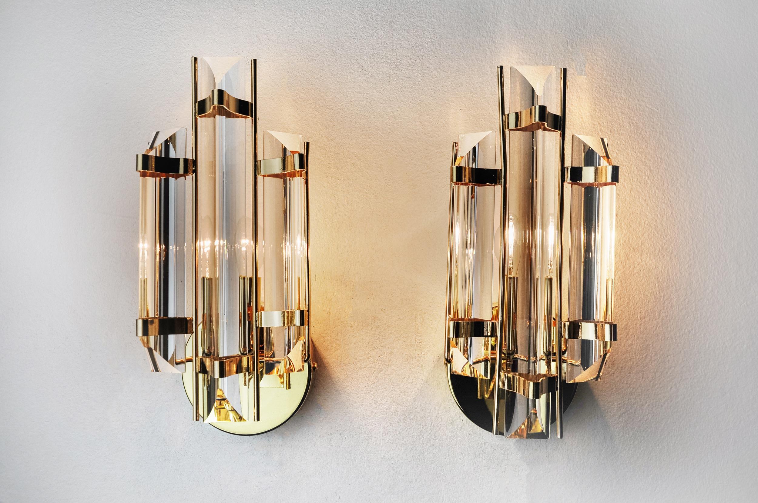 Very beautiful pair of Venini wall lights produced in Italy in the 70s. Cut glass and gold metal structure. Unique object that will illuminate wonderfully and bring a real designer touch to your interior. Electricity checked, time stamp consistent