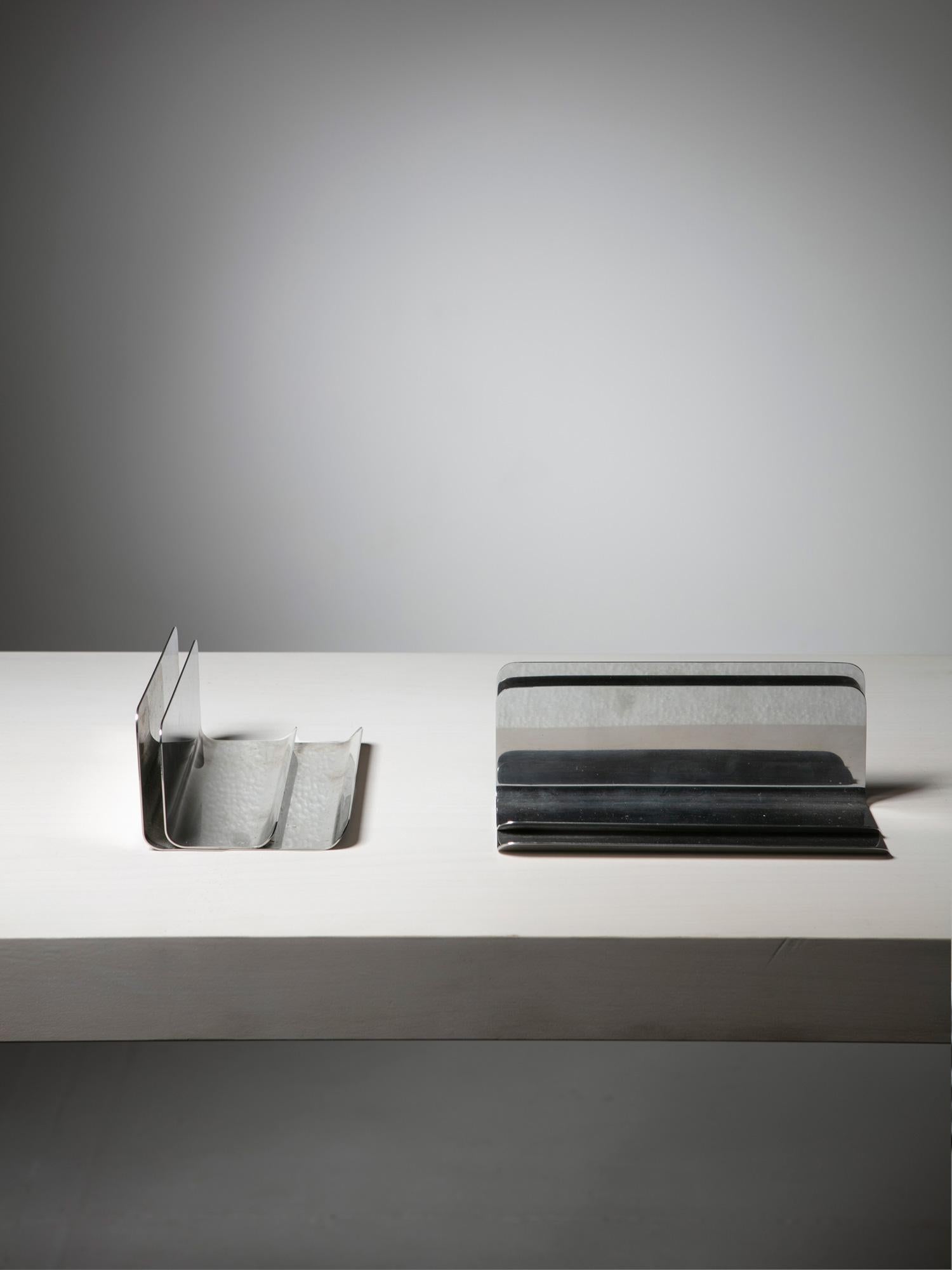 Set of two Ventotene desk sets by Enzo Mari for Danese.
Polished stainless steel elements featuring Vertical spaces to slip notepaper in, horizontal planes to put pencils on.
 