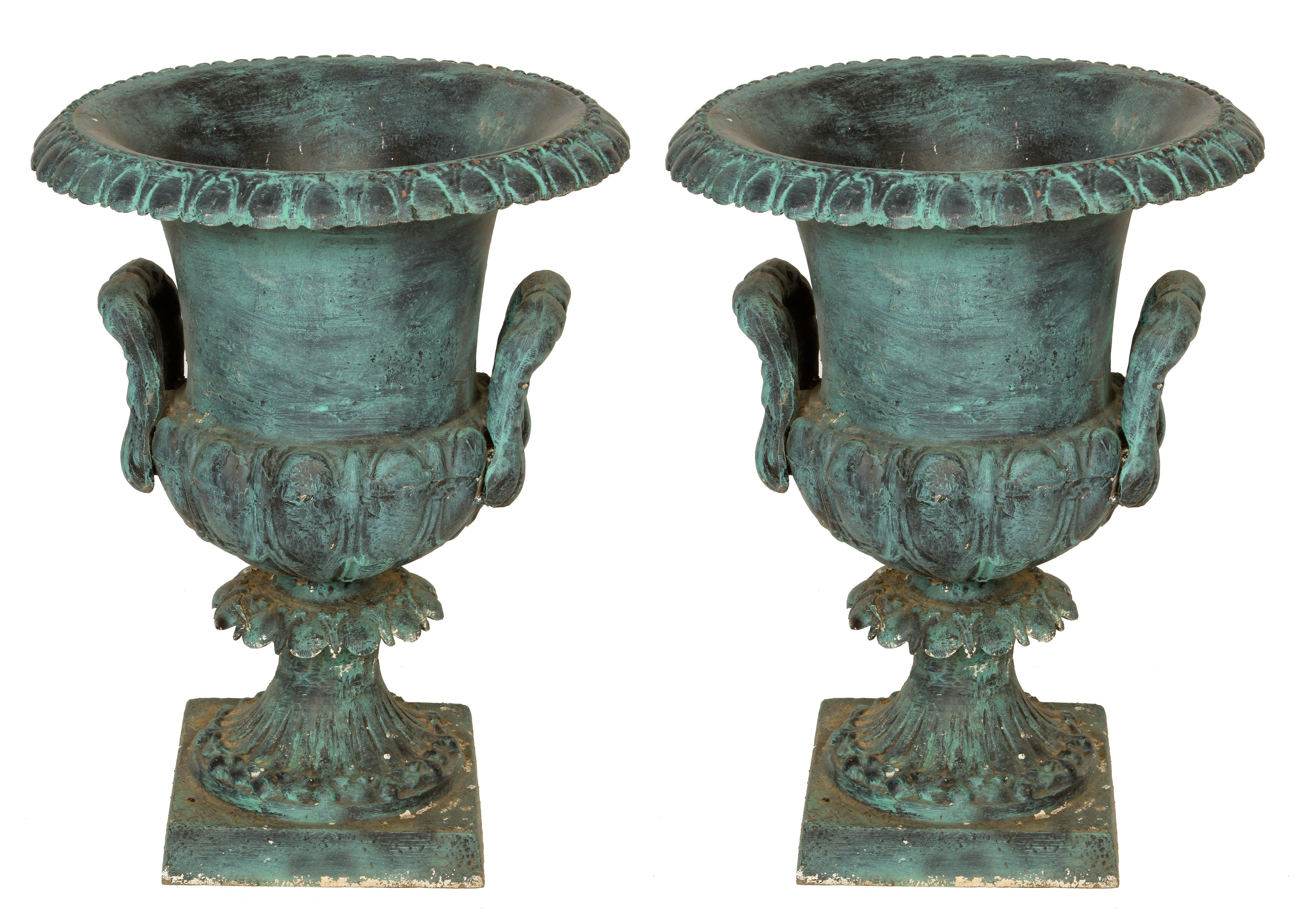 Pair of verdigris urns in Classic form with handles on each side.