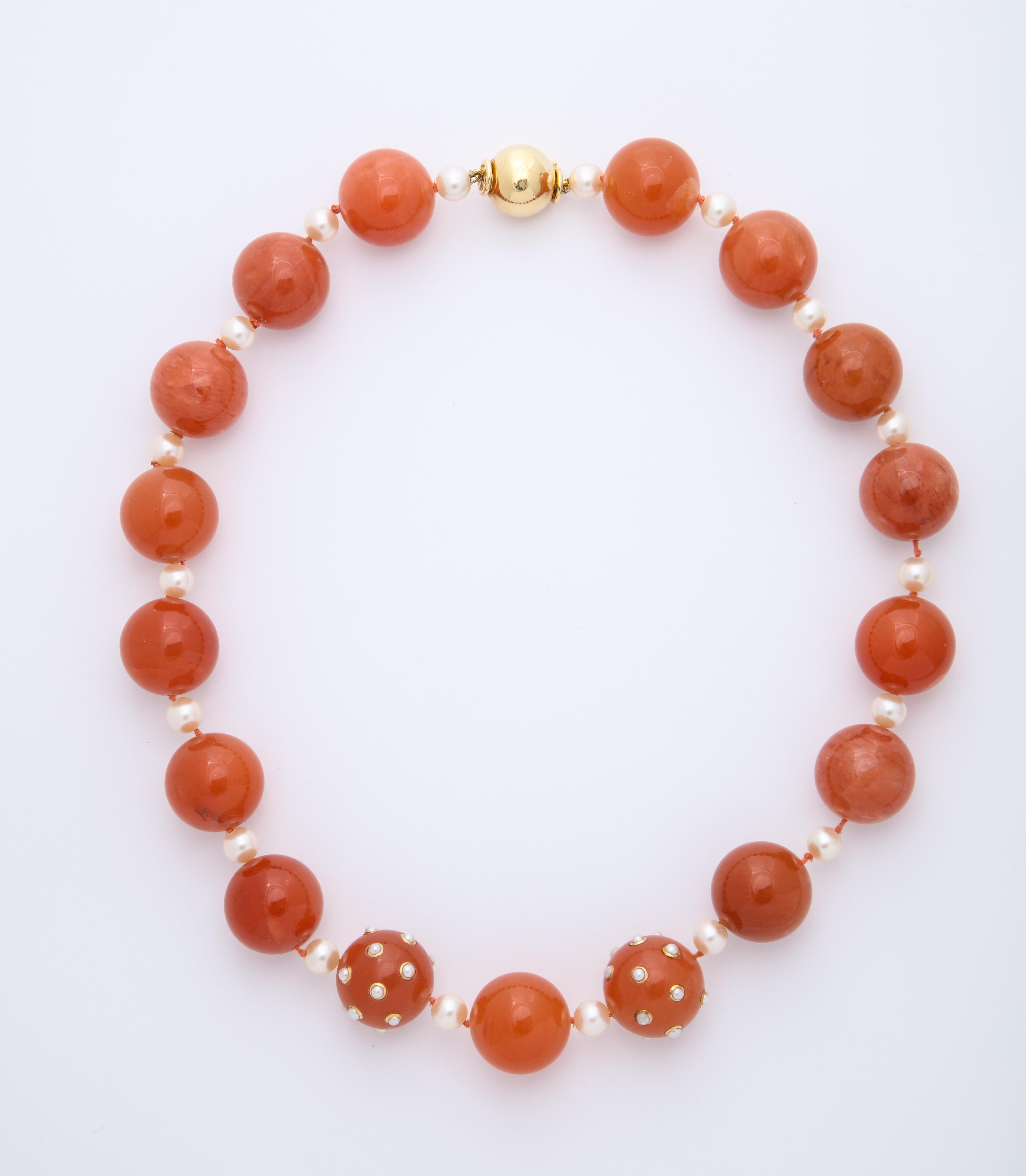 Bold and stylish pair of necklaces featuring carnelian beads, three of which are studded with bezel set pearls, by Verdura.
The 2 necklaces sit perfectly on the neck with one nestled inside the other (20 3/4 & 24 inches).
18kt yellow gold clasps.