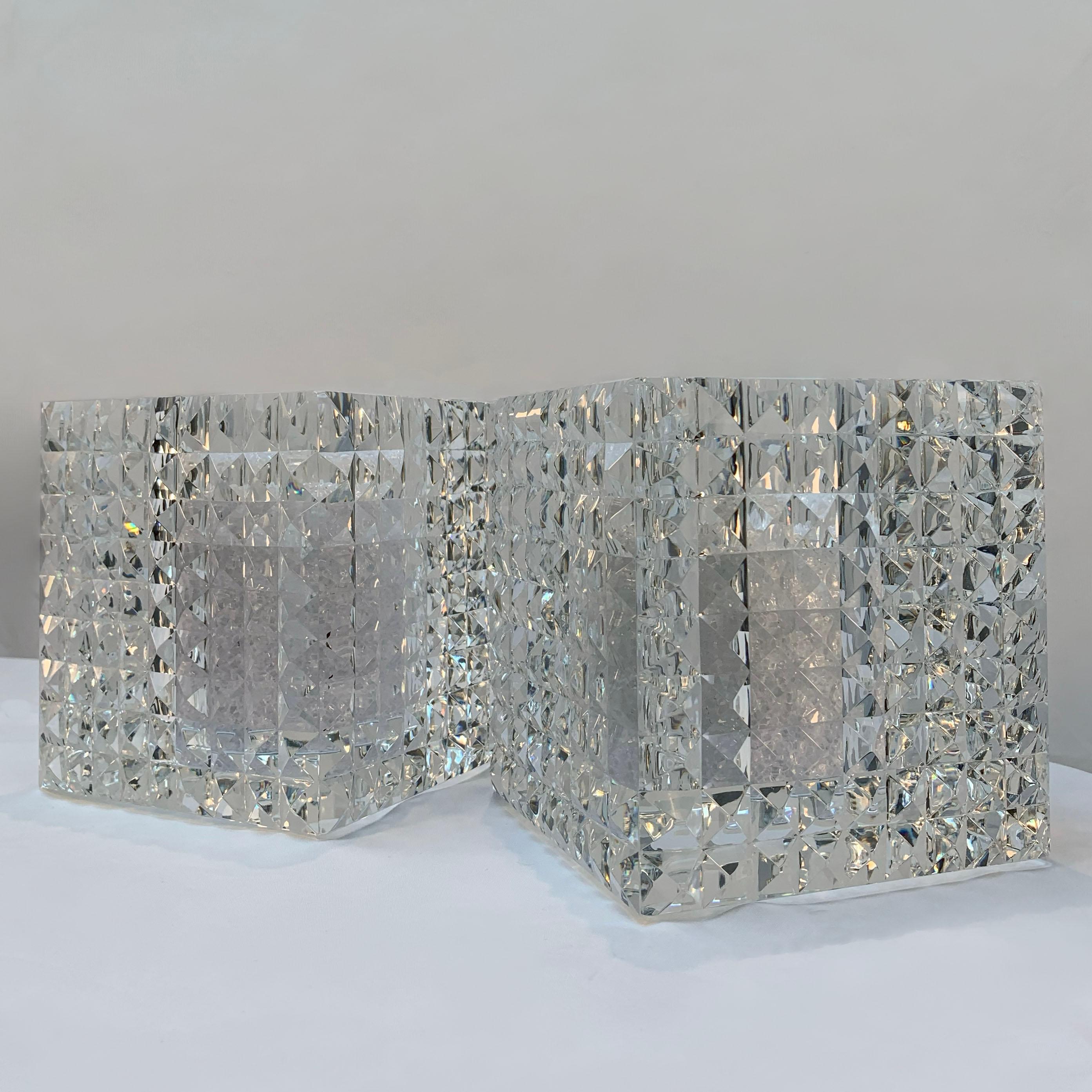 Pair of contemporary faceted optical glass square vases by Veritas, Texas, 2016, each hand-crafted in crystal-clear optical glass. The thick, heavyweight block form is precision-cut with a uniform pattern of pyramidal facets on all sides, refracting