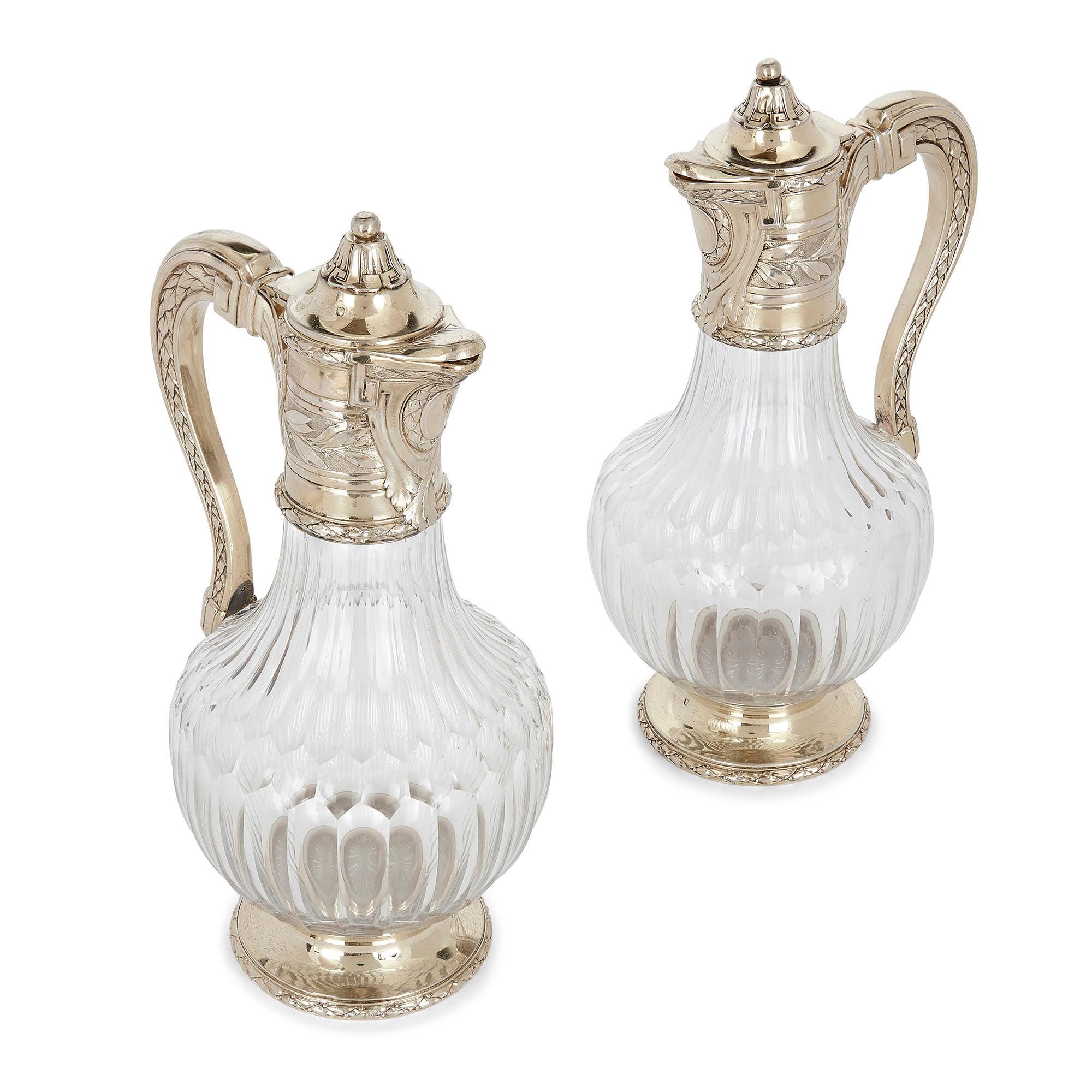 Pair of vermeil and cut glass claret jugs by Tétard
French, early 20th century
Measures: Height 27cm, width 14cm, depth 12cm

This superb pair of claret jugs is by the French firm Tétard Frères, a leading producer of luxury silverware. Each jug