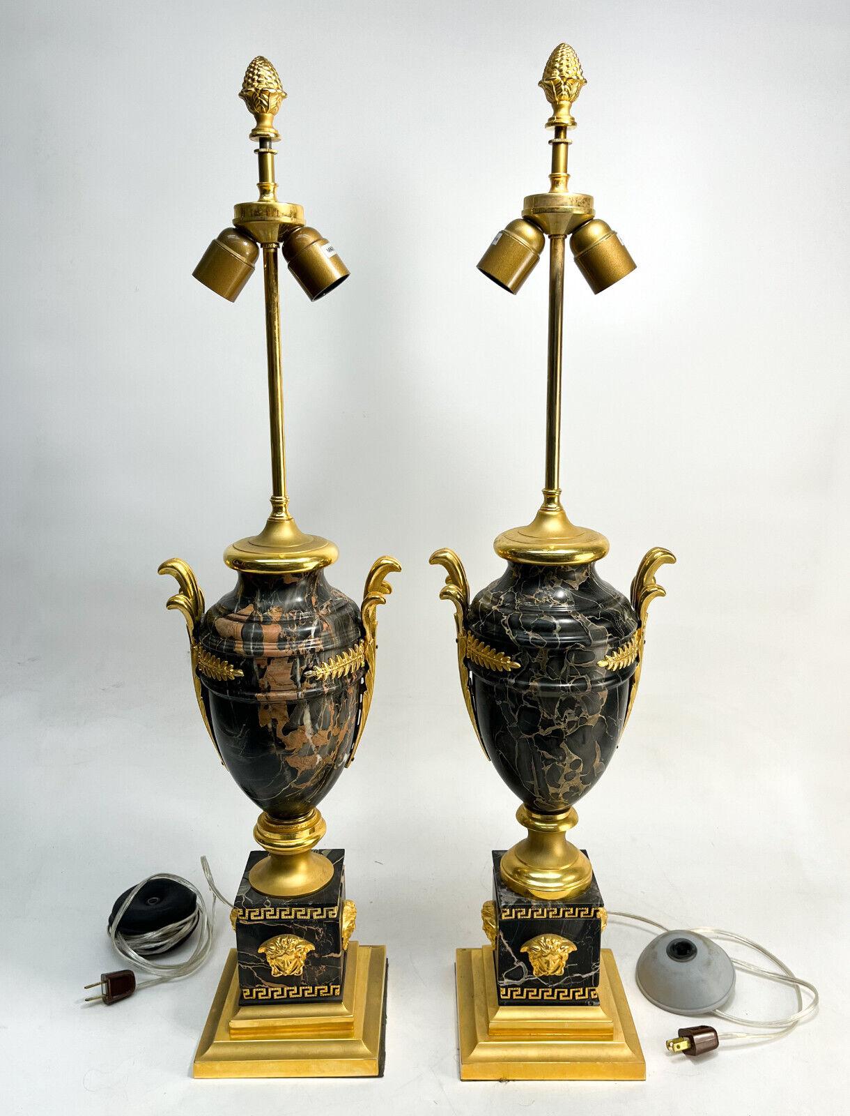 Pair of Versace Gilt bronze mounted marble lamps

A substantial pair of gilt bronze mounted veined pesco marble lamps in the Medusa pattern by Versace.Gilt bronze laurel leave mounts to the body with medusa heads to each wall of the base. Includes
