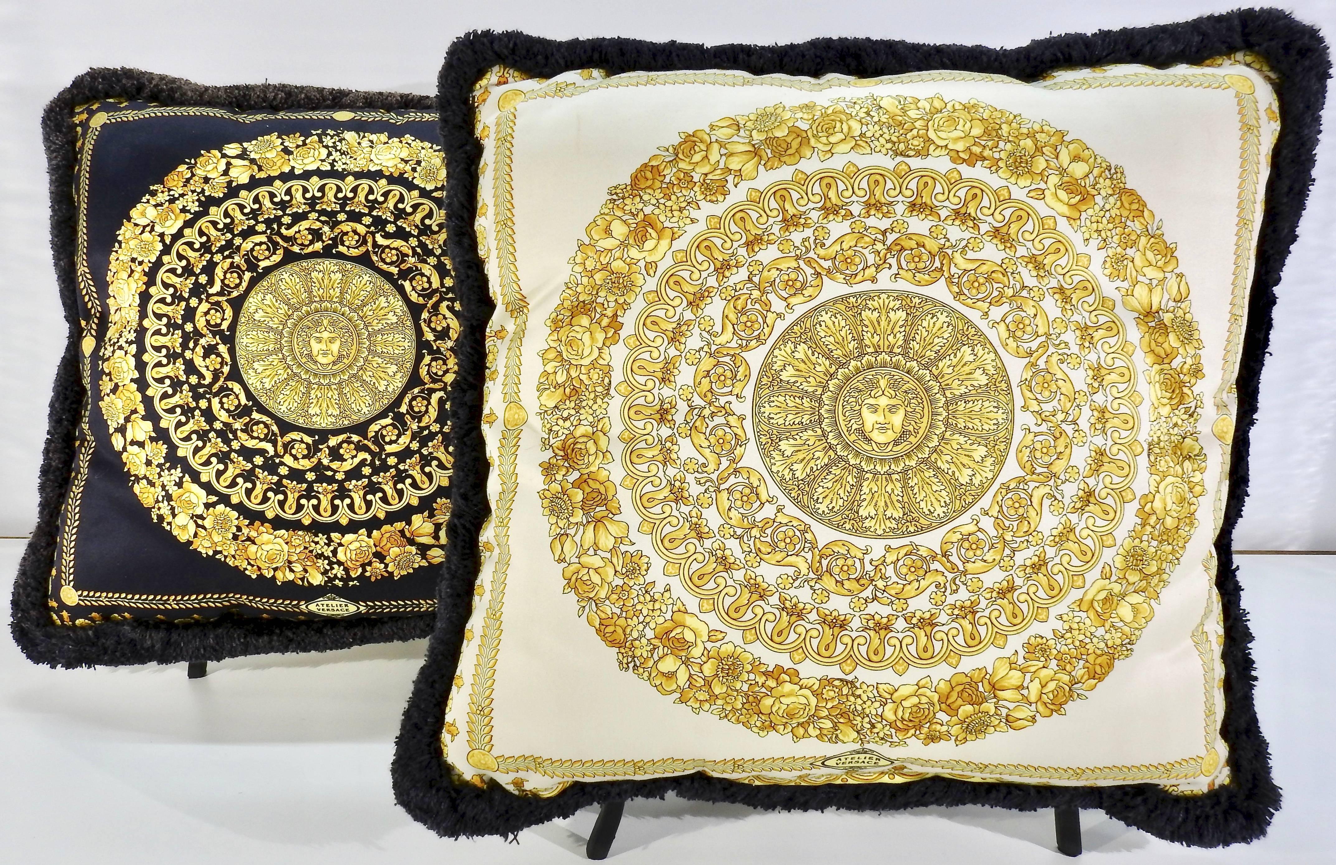 We are offering a nice pair of Atelier Versace pillows in the Medusa Royale pattern. Rich shades of gold framed by black on one side and white on the other offer you a variety of color. Rings of leaves and flowers circle the head of Medusa in the