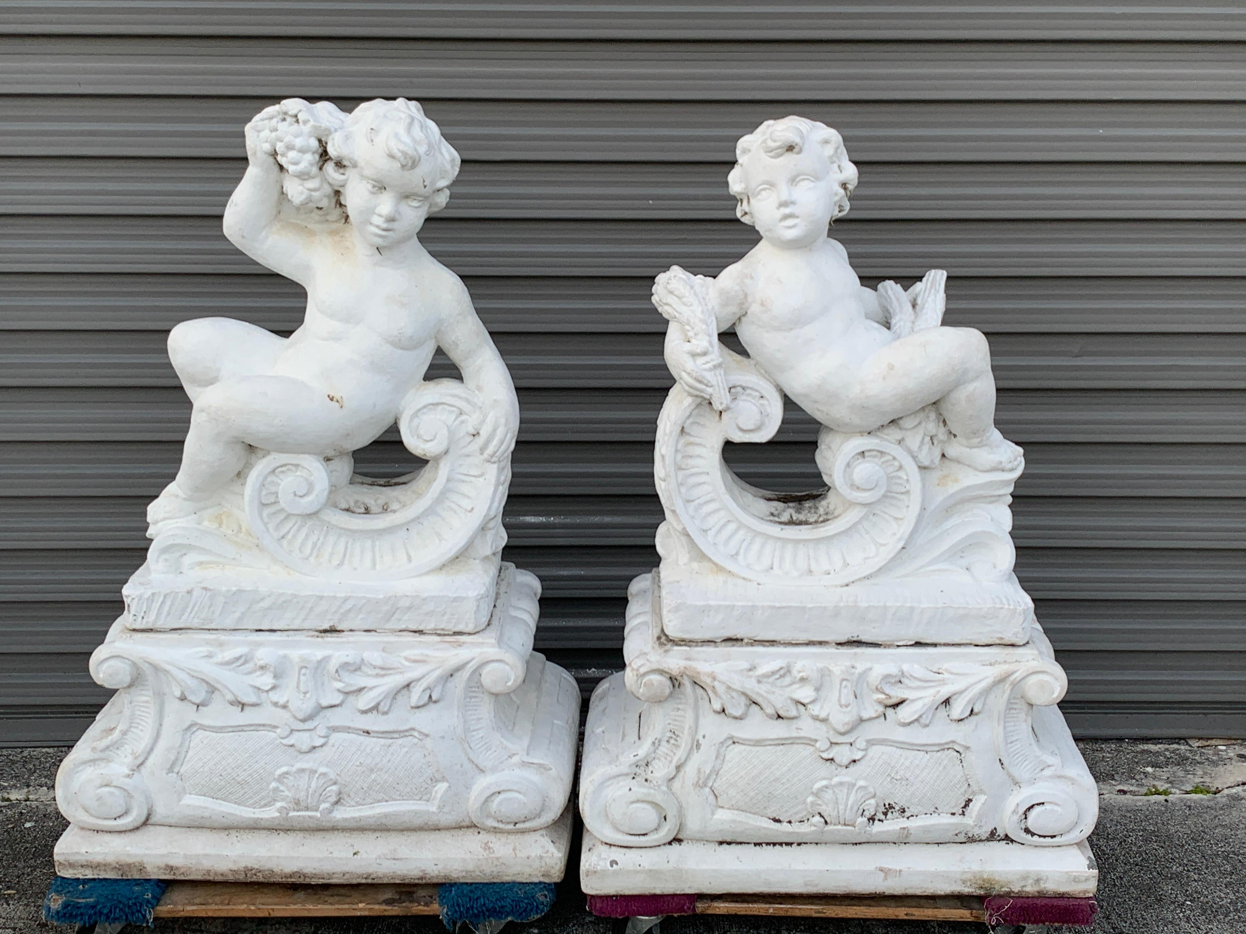 Pair of Vintage Cast Stone Statues of Recumbent Putti on Pedestal Bases In Good Condition In West Palm Beach, FL