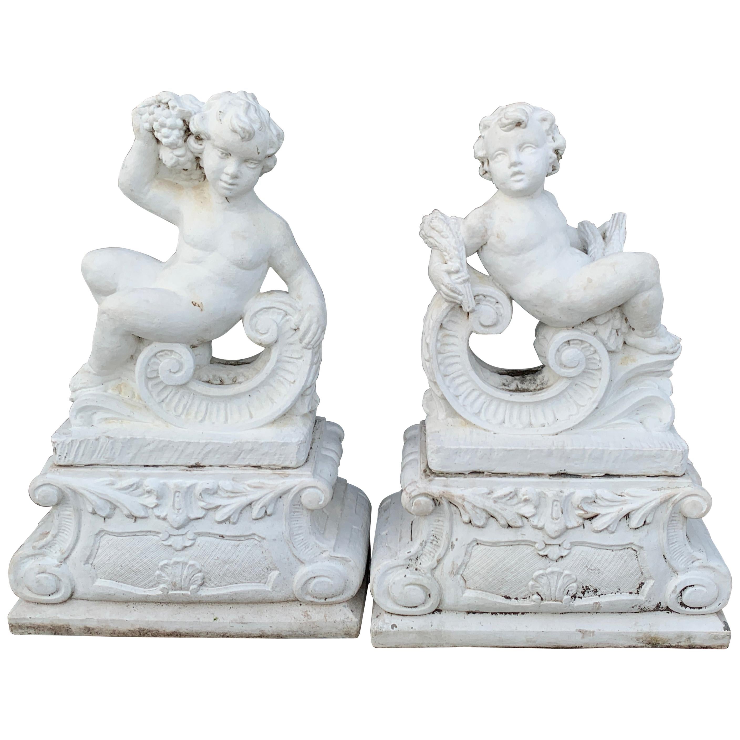 Pair of Vintage Cast Stone Statues of Recumbent Putti on Pedestal Bases