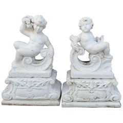 Pair of Vintage Cast Stone Statues of Recumbent Putti on Pedestal Bases