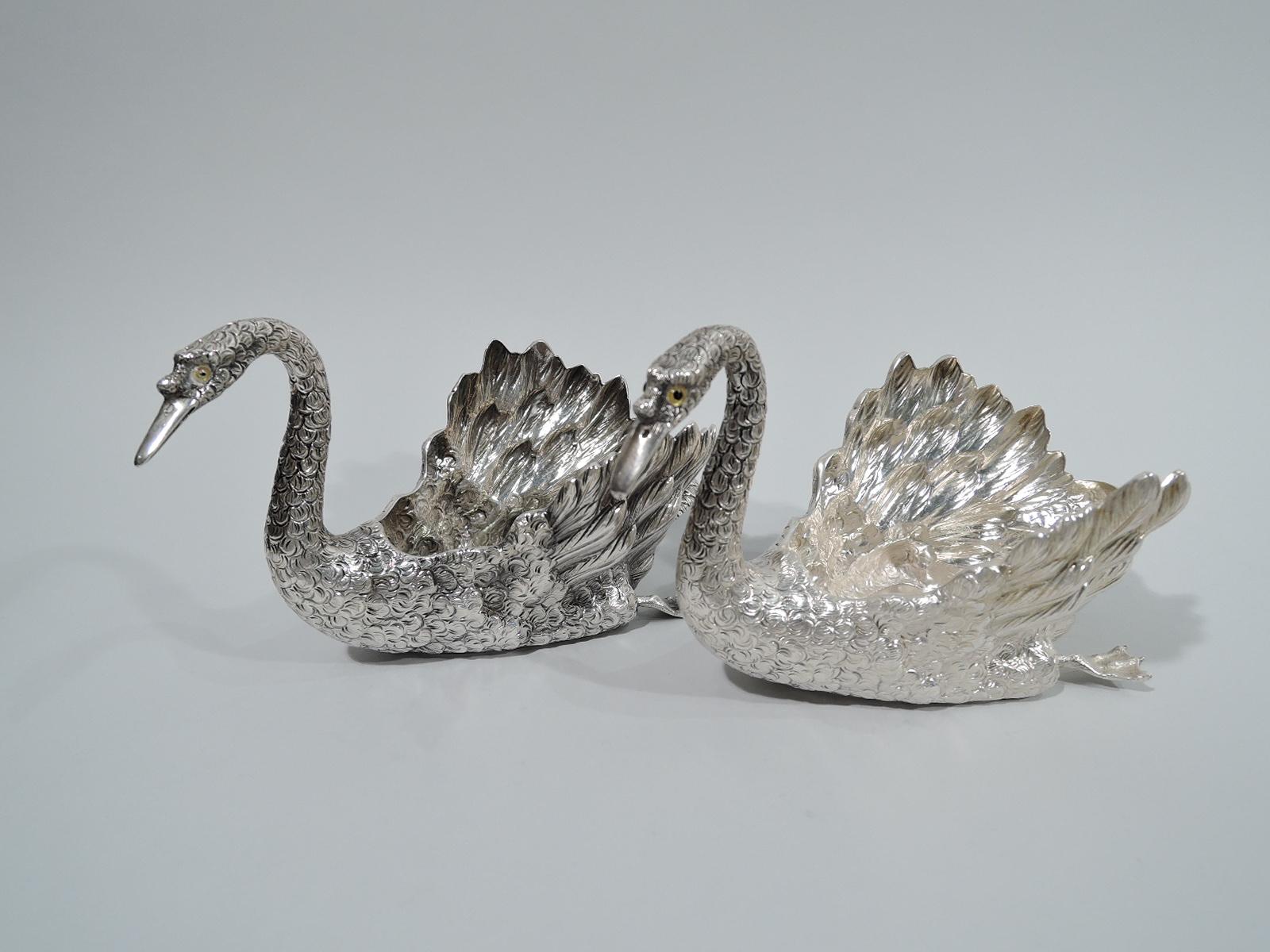 Pair of very desirable sterling silver swans. Made by Buccellati in Italy. Each: Hollow body with graceful scrolled neck, pointed bill, brown glass bead eyes, and paddling webbed feet. Realistic plumage from scaly to fluffy. Beautiful birds by the