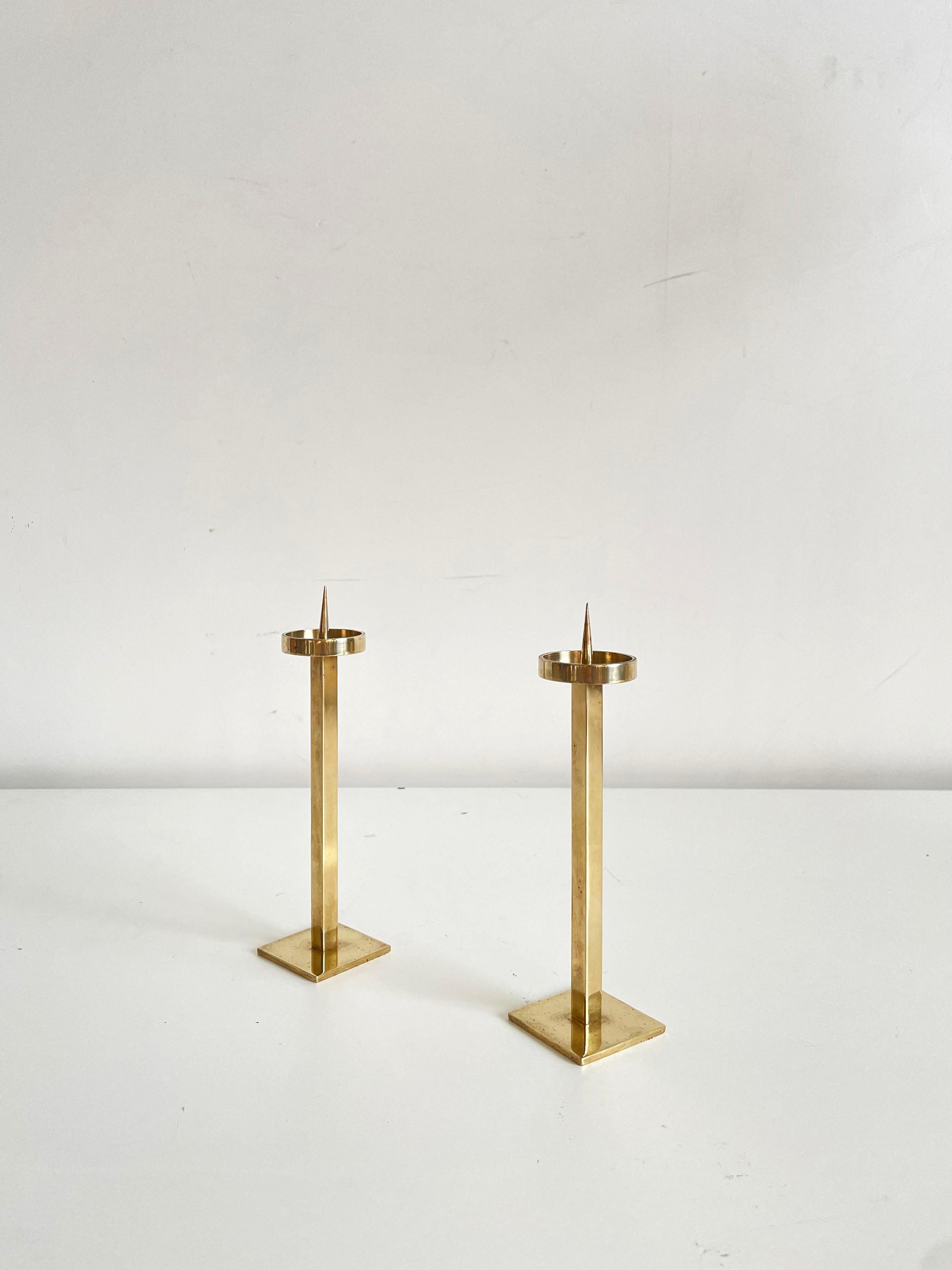 Pair of vintage Mid-century solid brass candlestick holders in shiny gold color

Small size, sophisticated slender minimalist form, but cannot get unnoticed 

diameter of the candle cup is 3.5 cm

The candle holders are in very good vintage