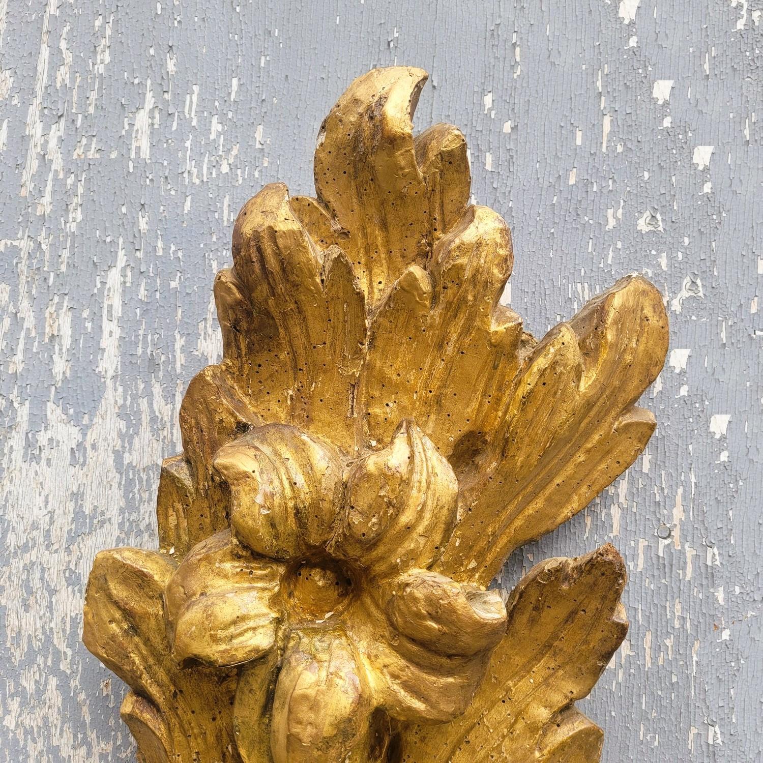 Pair of large wall lights in gilded and carved wood, each with 4 iron light arms.   

17th century wood, assembled at the beginning of the 20th century.  

 Electricity to be reviewed (especially to local standards), wear and tear, missing parts and