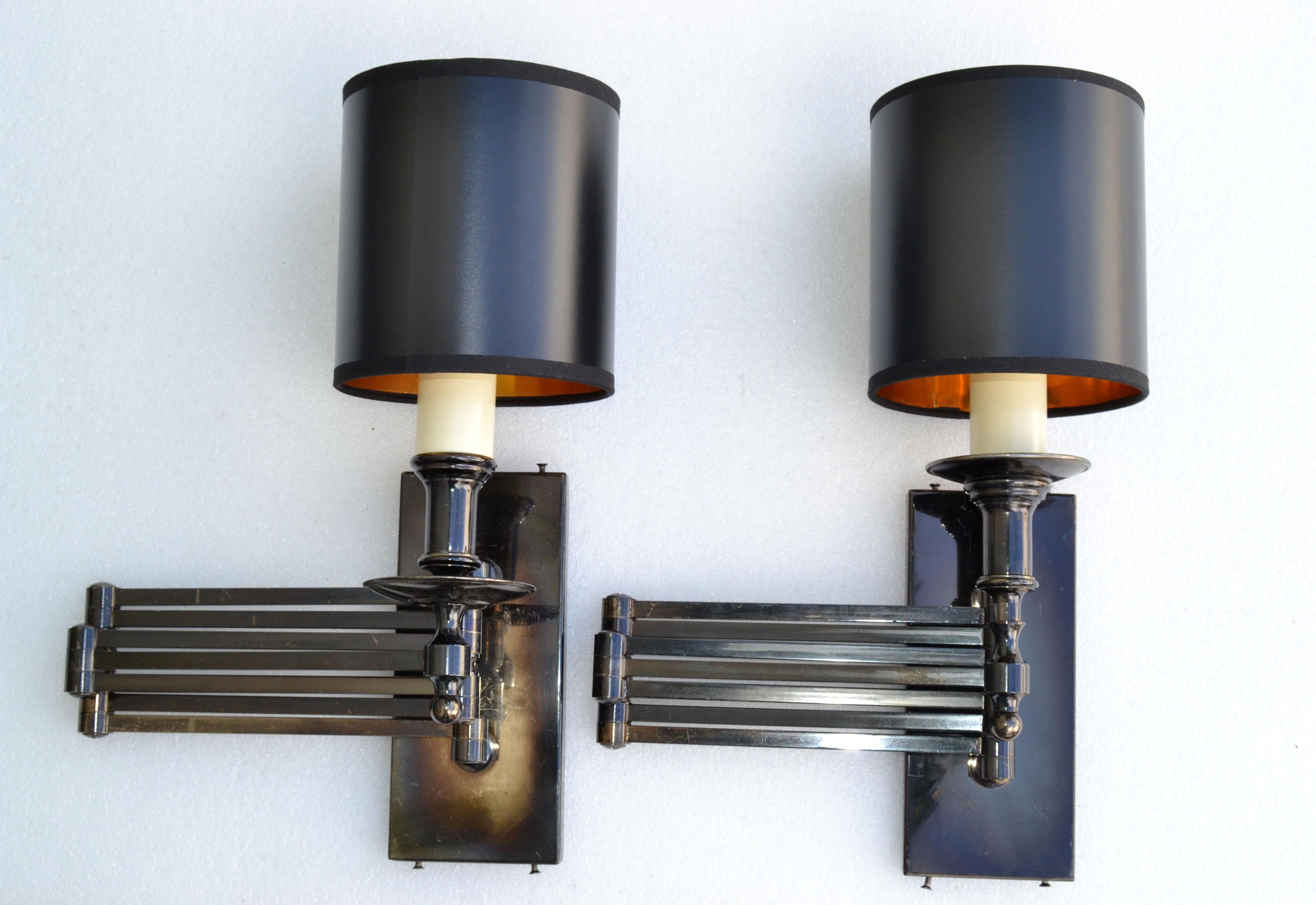 Unusual and impressive pair of very tall Maison Jansen retractable sconces.
Mid-Century Modern two-tone brass and gun metal wall lights made in France.
US Rewired and in working condition each take 1 regular or LED bulb. 
Dimension, max extended