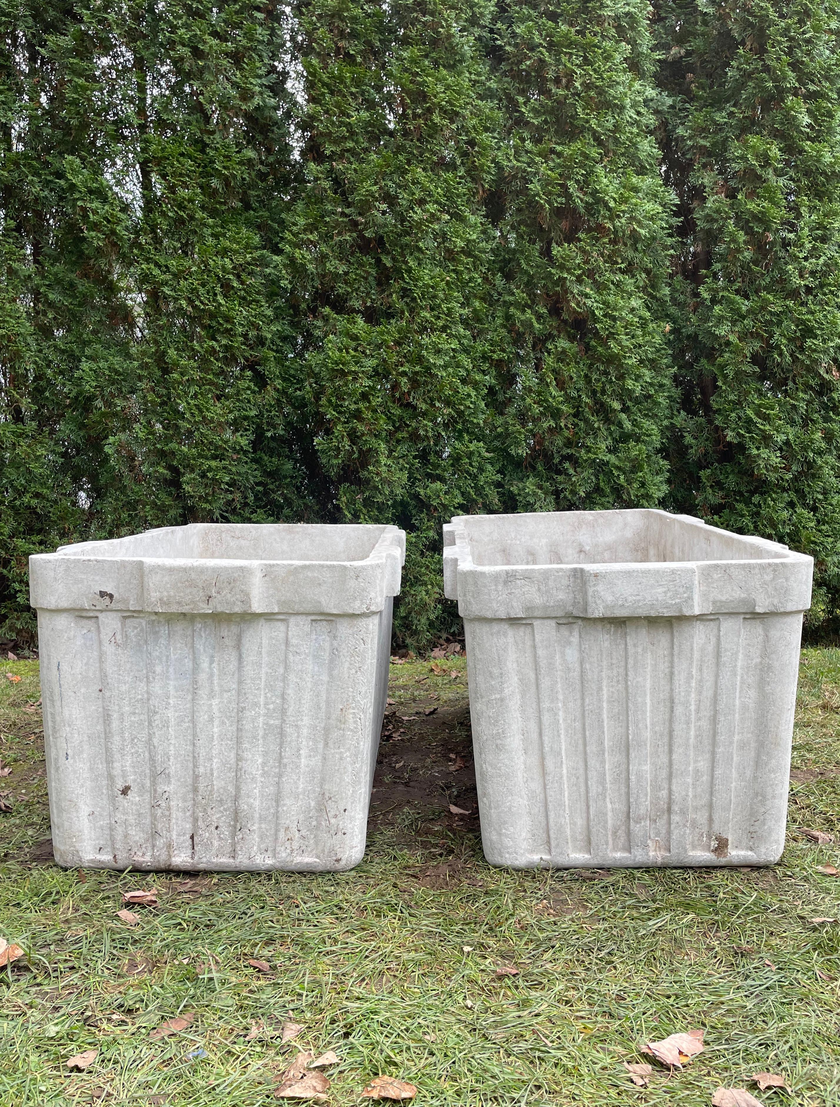 These very large rectangular ribbed planters with integral handles on two sides were designed by the iconic Willy Guhl and produced by Eternit of Switzerland. In excellent condition, they feature a lightly-patinated natural (unpainted) surface and