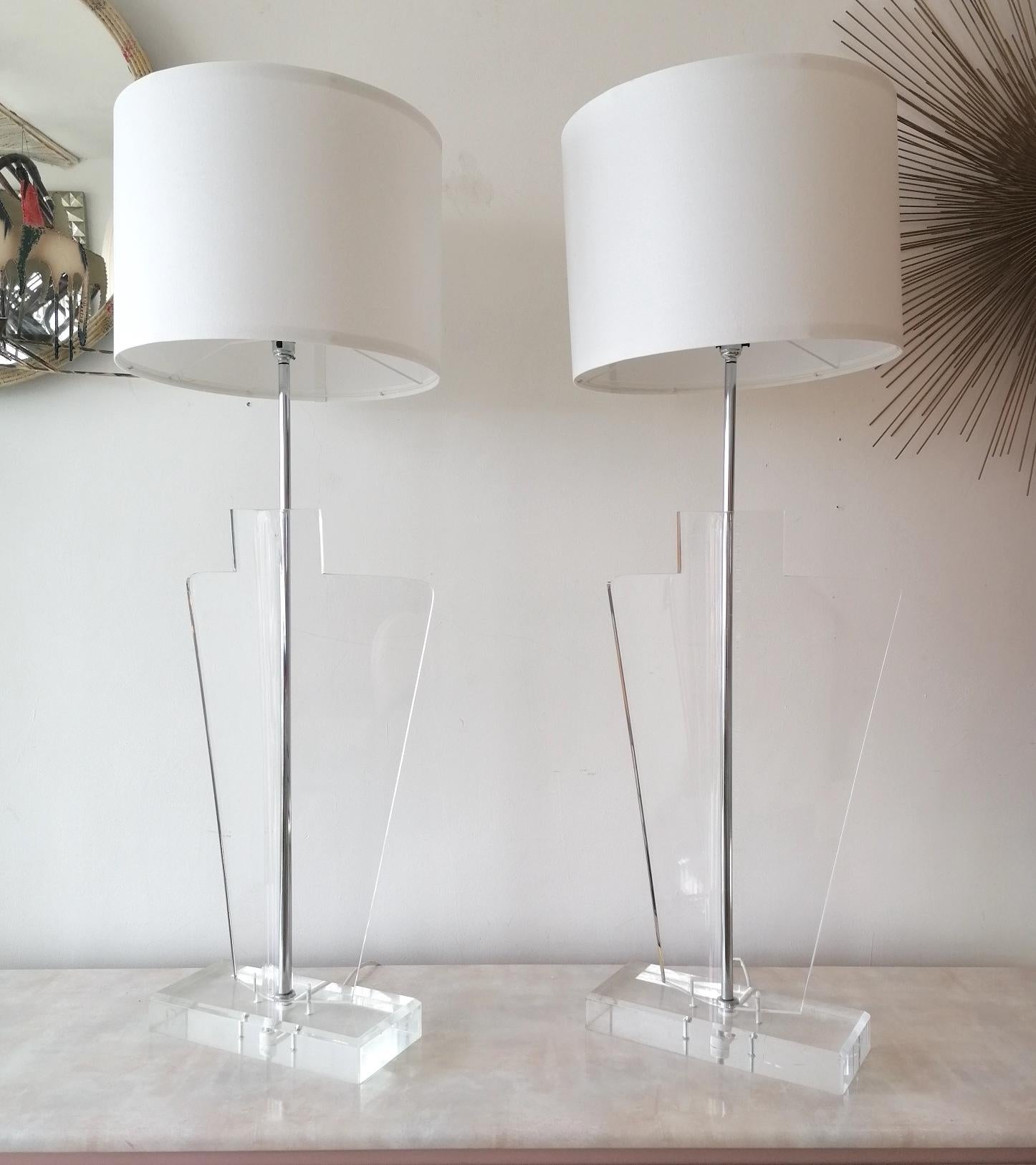 Pair of strikingly large Art Deco Revival lucite & chrome lamps, 1970s Italian. No makers label remaining, so the designer is unknown, as yet.
Newly rewired.

Dimensions : height to top of bulb holder 96cm, width of lucite body 43cm, height to