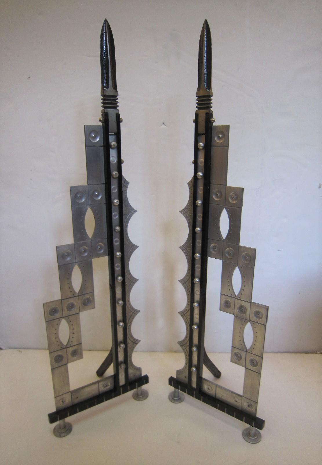 Pair of large Art Deco revival handcrafted spear head andirons in steel and iron.
A highly unusual pair with lovely details that feature design influences combining architectural elements, skyscraper, stepped motif, arts and crafts and modernist