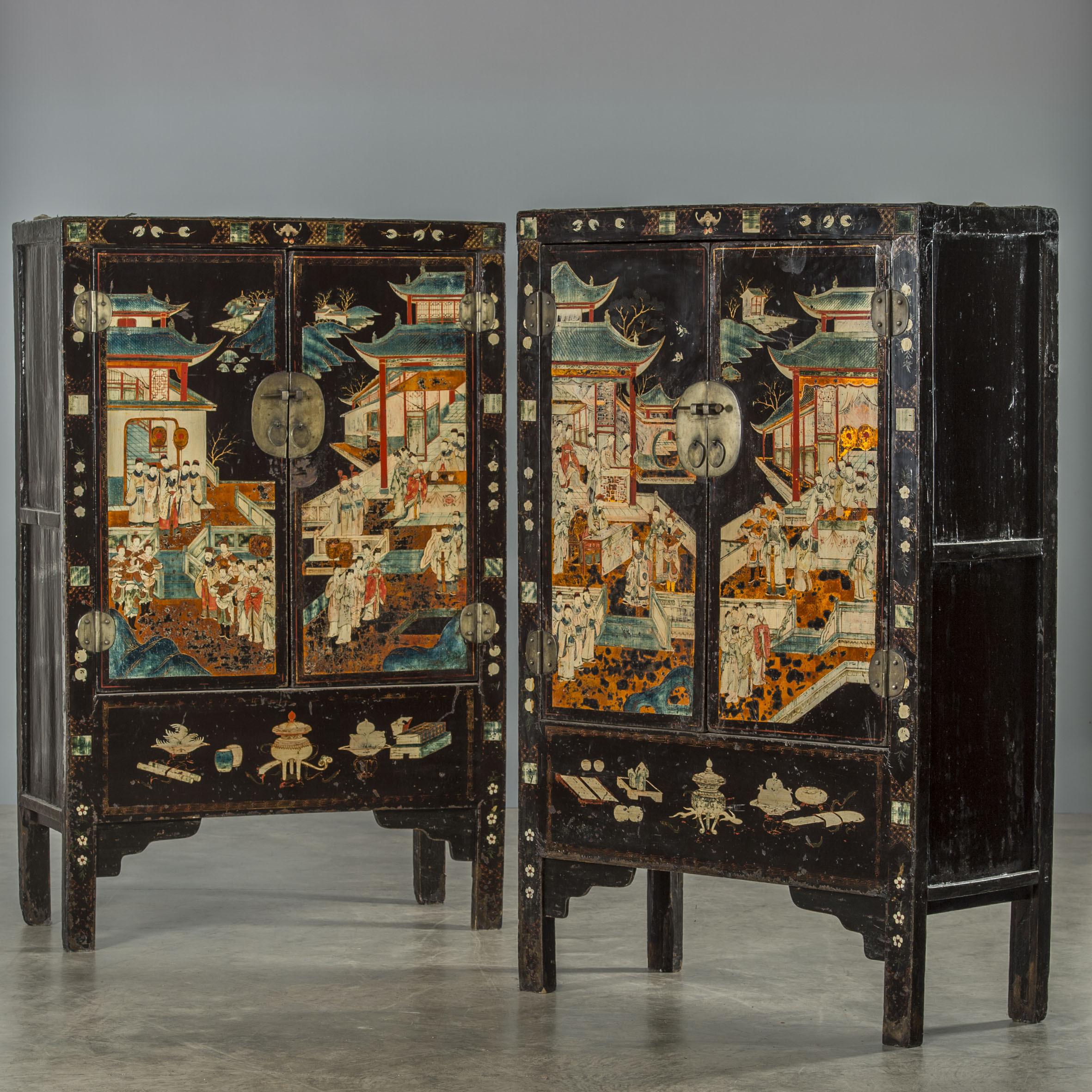 Pair of unusually beautiful cabinets in black lacquer with well-preserved original decorations in polychrome, showing houses and people. The cabinets are rarely seen today. Dating 1700s Qing dynasty. From Shanxi province in China.