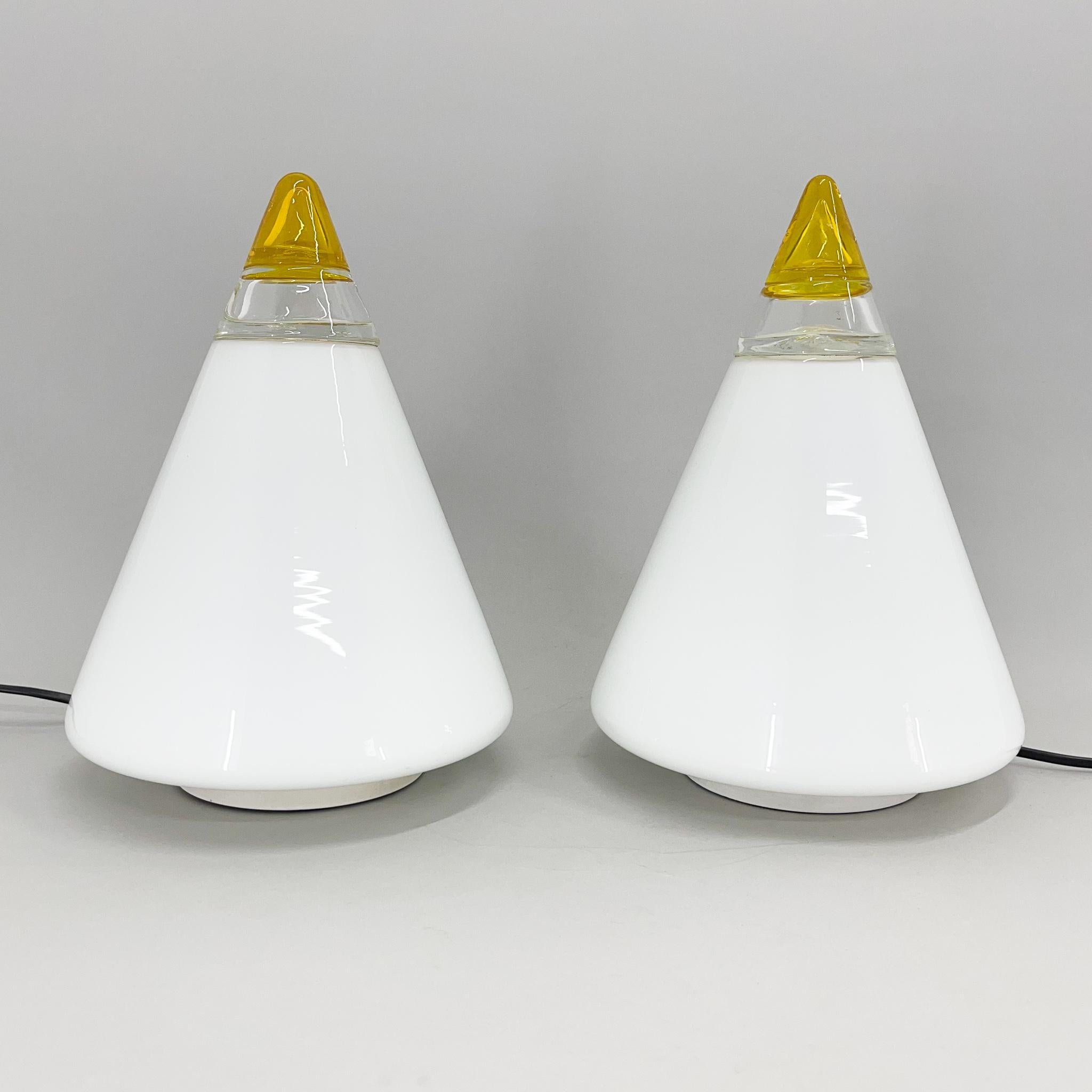Set of two beautiful Italian table lamps designed by Giusto Toso and manufactured by Vetri Murano in the 1970's. 
Made of opaline glass cone with yellow crystal top. 
Labeled with Vetri Murano 048.
Bulb: 1 x E25-E27, each.
