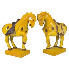 Pareja de caballos de mayólica italiana amarilla vibrante de la Tang Dynasty