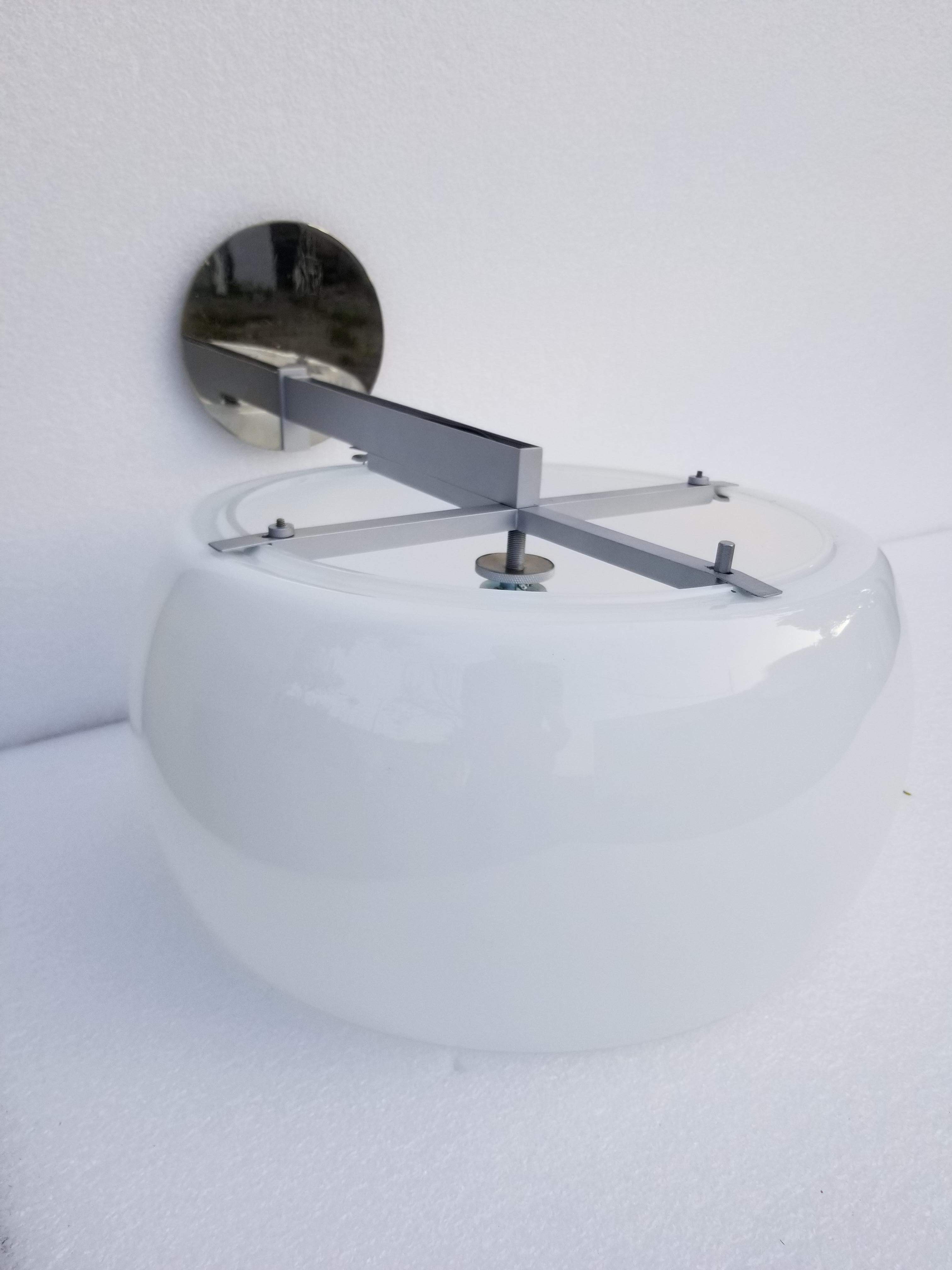Pair of Vico Magistretti for Artremide wall sconces.
Made in Italy, early production circa 1961.
Nickel-plated frame and opaline round glass
Restored and US rewired, new 100 watt max socket
Measures: Back plate diameter 6 inches
Have a look at