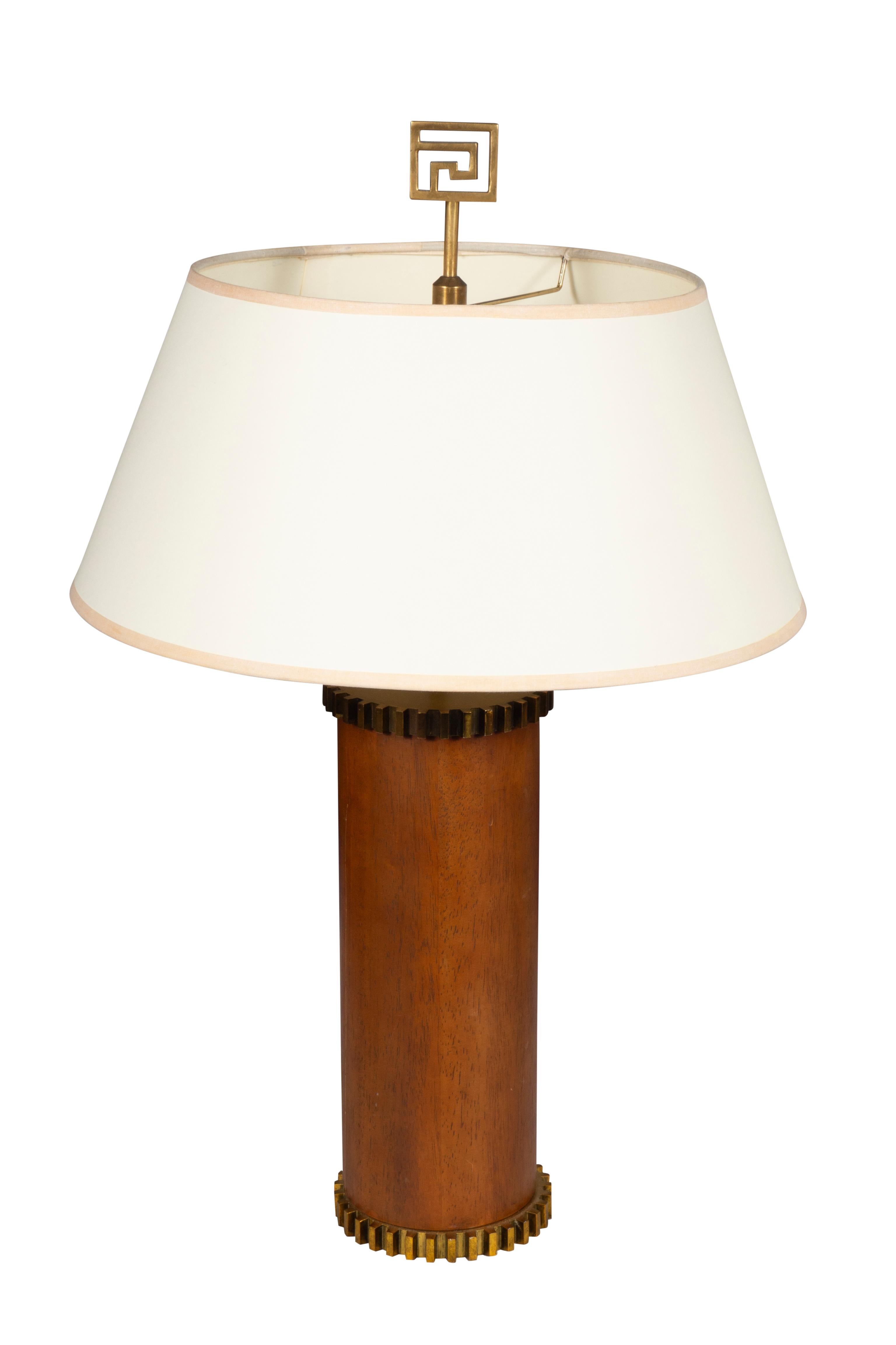 Cylindrical with brass cog ends. Single light with shades and finials.