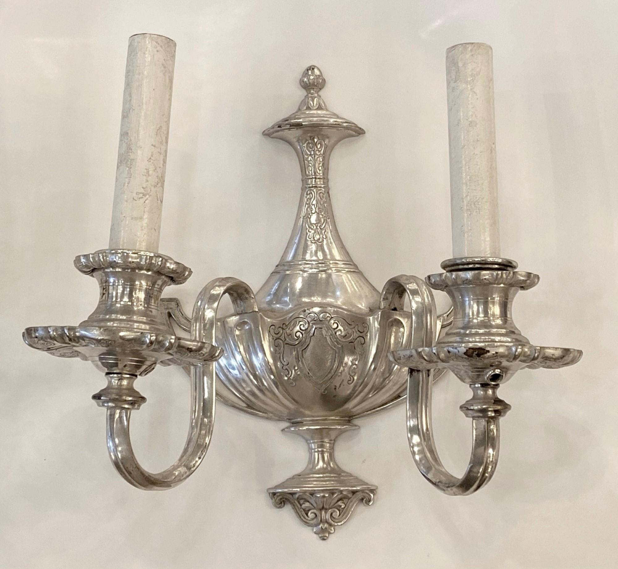 Cast brass two arm sconces with silver plating. Priced as a pair. Cleaned and rewired. Early 20th century done in a Victorian style. Please note, this item is located in one of our NYC locations.