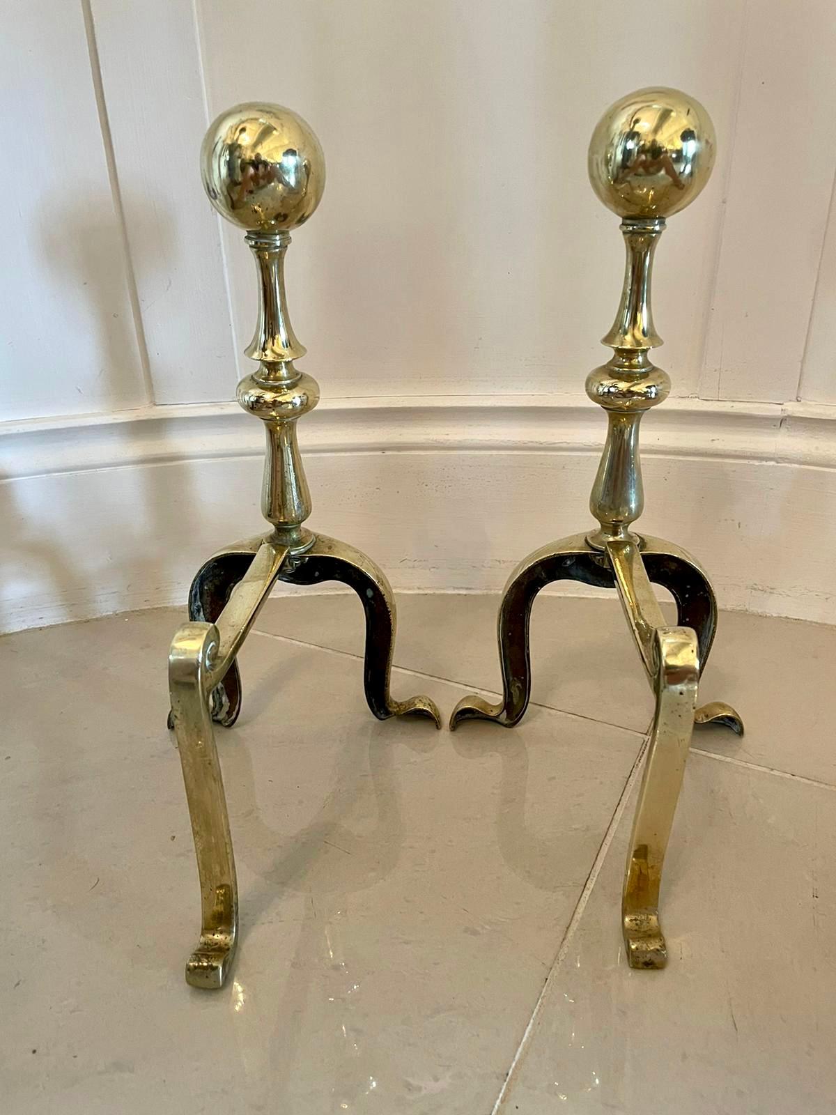 Pair of Victorian antique brass fire dogs having large round brass balls, turned column supports and raised on shaped brass cabriole legs to the front and shaped back legs which are united by brass rails.

Lovely original examples in fine