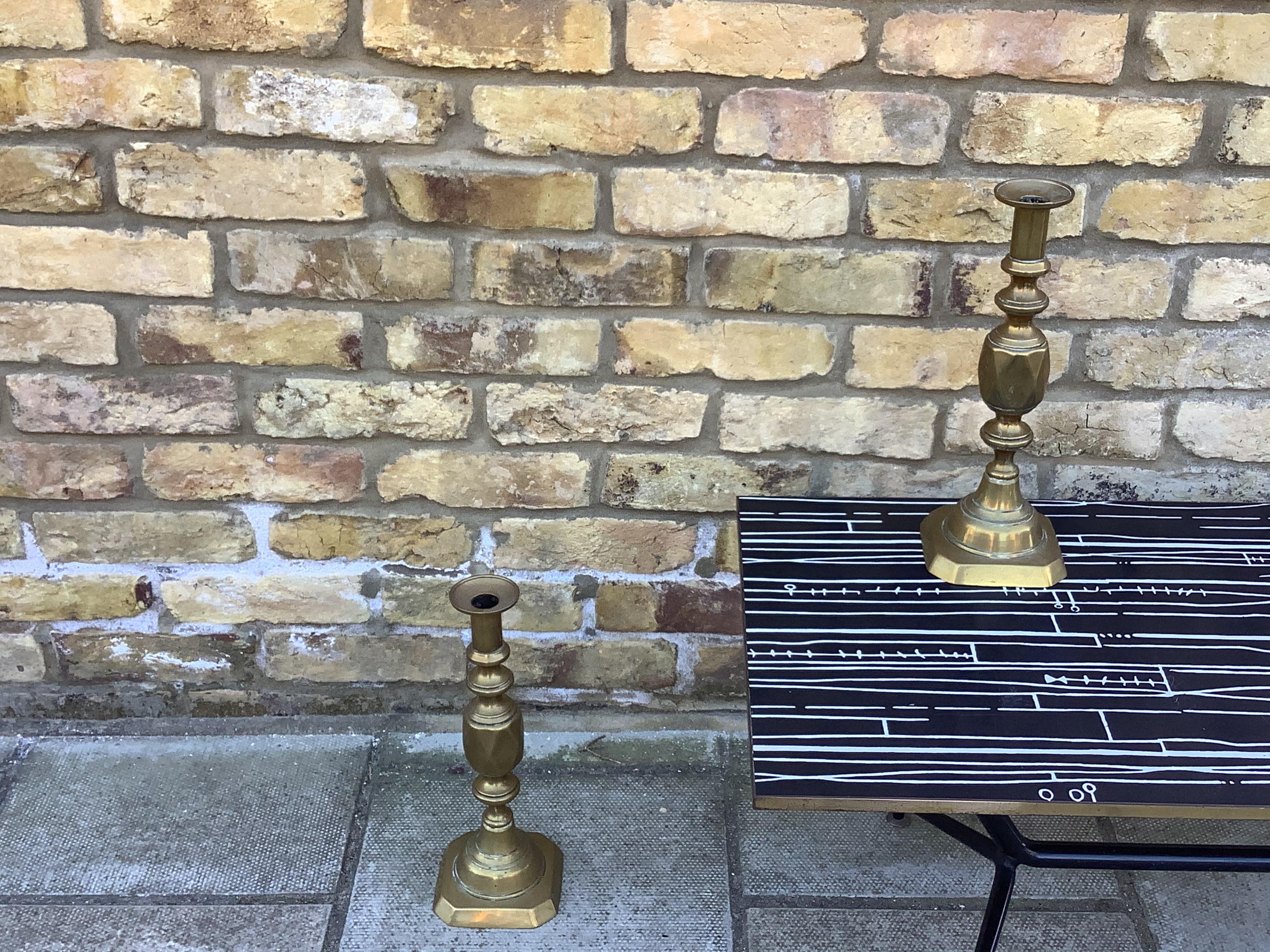 A pair of antique Victorian solid brass push up candlesticks. Part of a series made to commemorate Queen Victoria’s Diamond Jubilee in 1897 and the rarest of the set.

In good condition. The flat base is missing from one of the push ups underneath