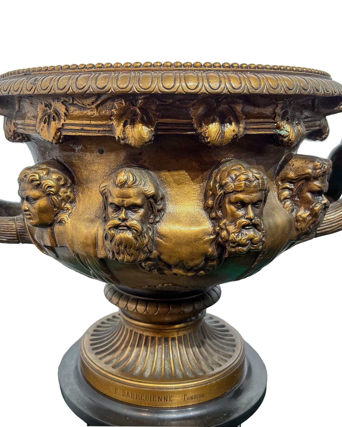 A patinated bronze model of the Warwick vase with Bacchic ornament by the Barbedienne foundry. Modeled after the celebrated ancient Roman marble vase, discovered in fragments in 1771 in the ruins of Hardian's villa near Tivoli by the Scottish artist