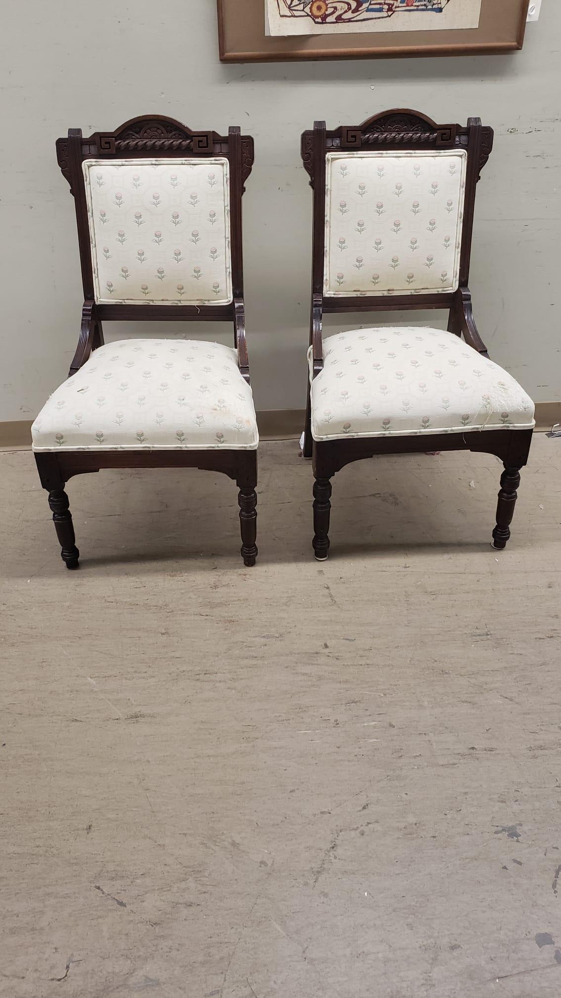 A pair of Victorian Carved walnut and Upholstered Side chairs in good antique condition. Measures 19