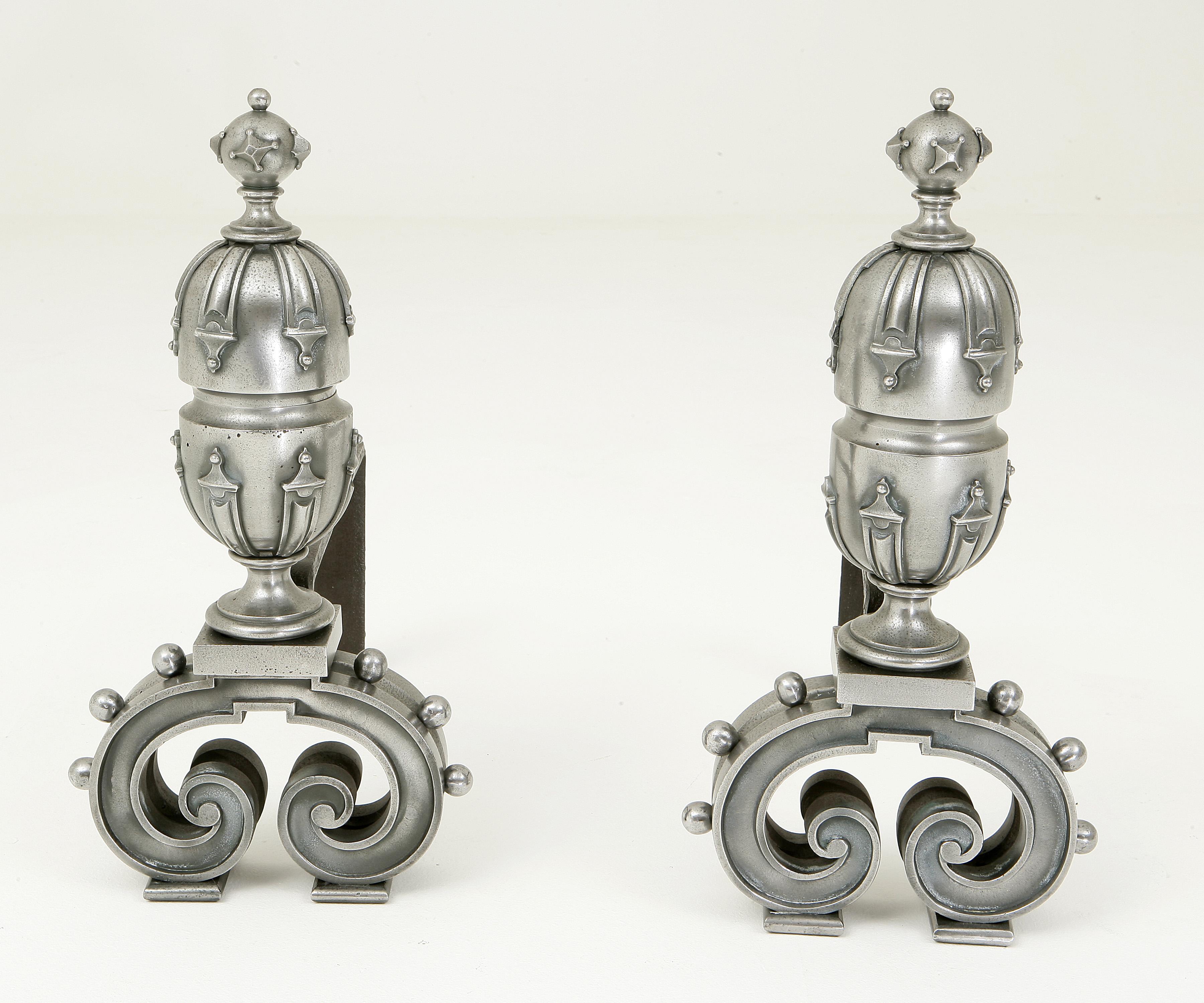 A pair of polished cast iron andirons, in the Elizabethan revival style. English, 1870.