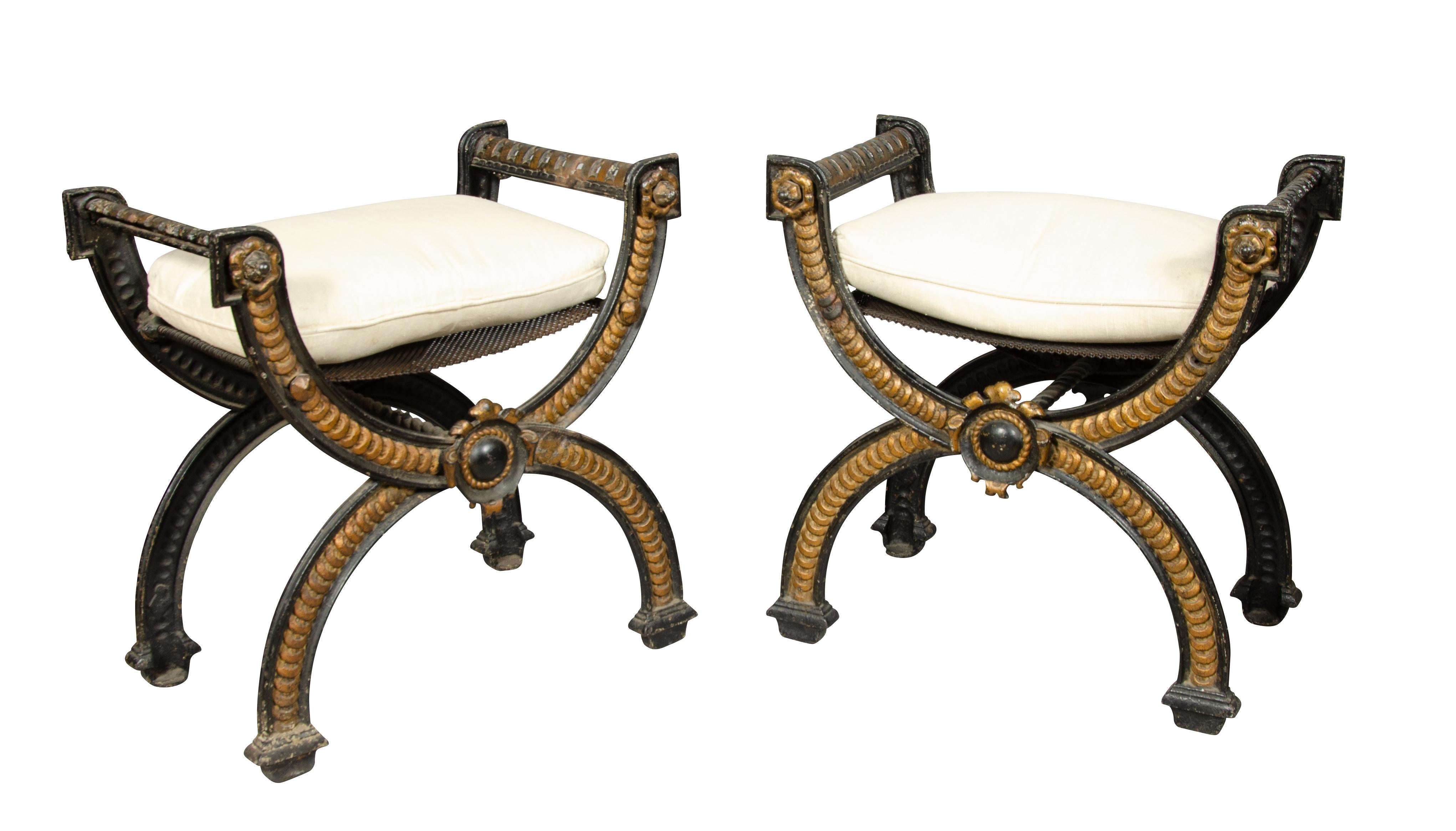 Painted black with gold decoration. Guilloche cast decoration on legs [overlapping coin]. Curule form inspired from ancient Greece. Cushion seat.