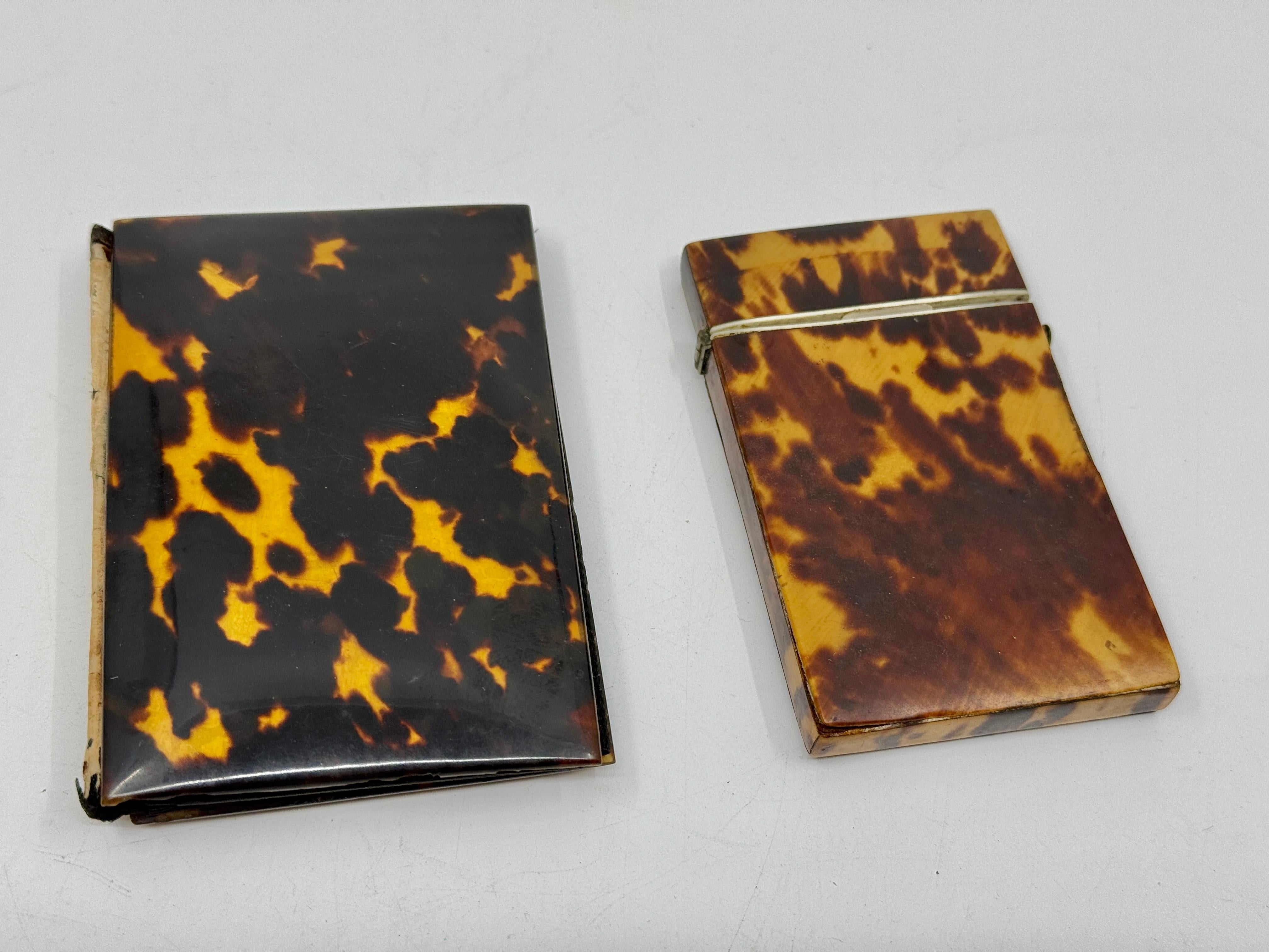 A lovely pair of antique Victorian 19th Century Horn card cases. Beautifully grained these antique pieces were descended from the same family estate. The first has a flip top that releases with the push of a button. This p[ieces has some missing