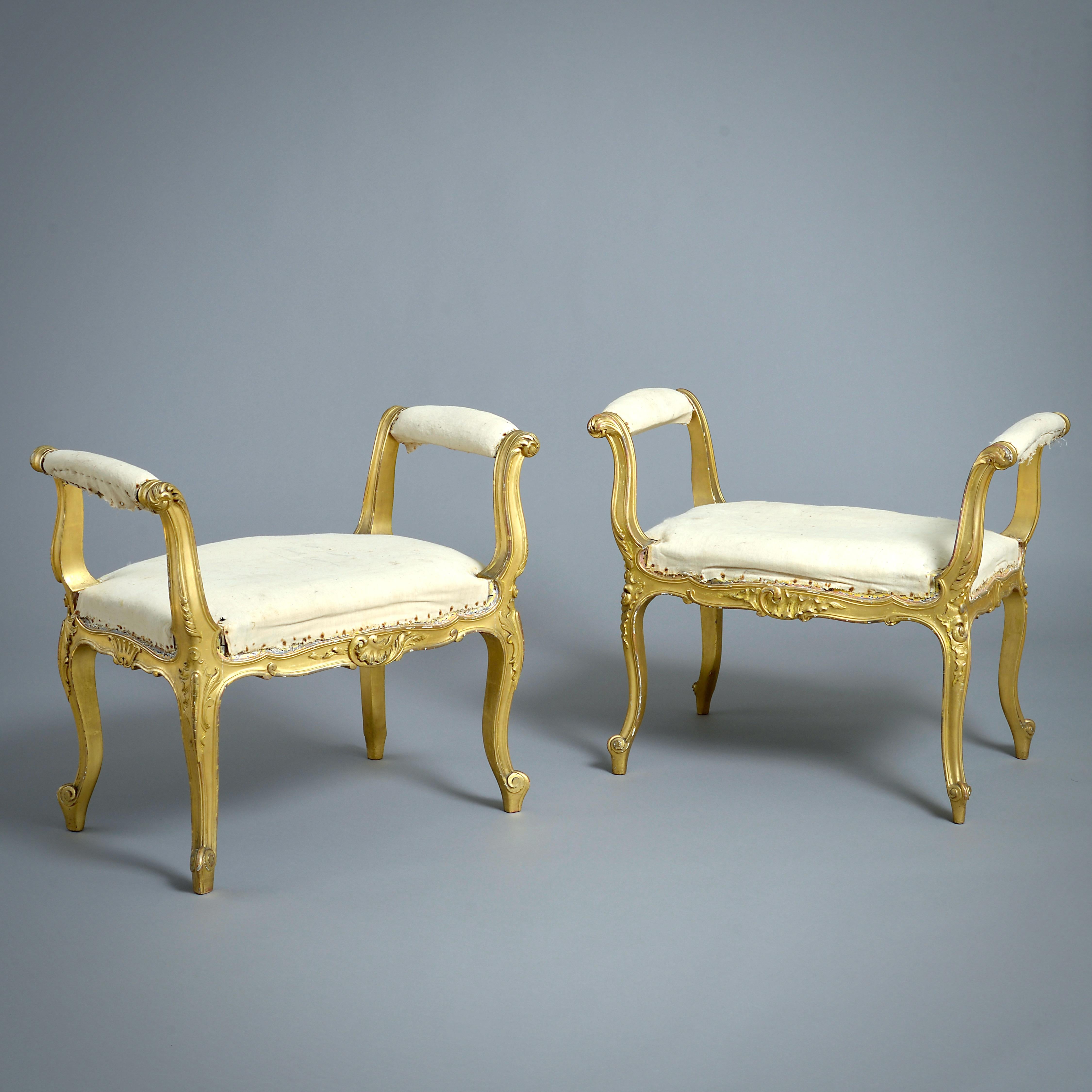 A PAIR OF VICTORIAN GILT-WOOD STOOLS BY JAMES SHOOLBRED & CO., CIRCA 1890.

The gilding original. Each with ivorine label inscribed 'Jas Shoolbred & Co. Tottenham Ct. Rd. London'

Provenance:
the Viscounts Mountgarret, Nidd Hall, Yorkshire.