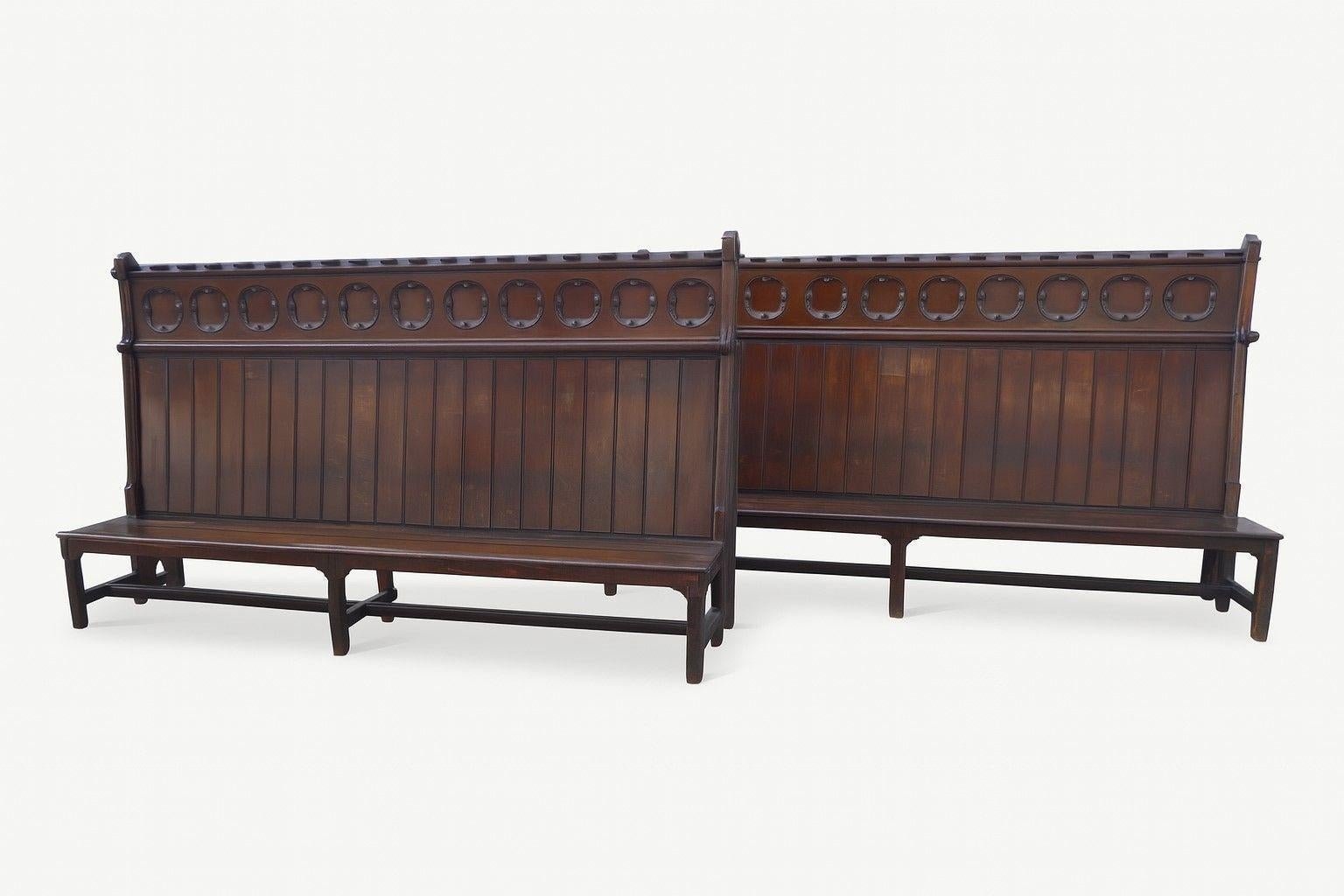 Pair of Impressive Gothic Revival Oak Hall Benches
Item Code: S25-338
An exceptional pair of late 19th century Gothic Revival oak hall benches, each of impressive scale and presence. The high backs are adorned with carved blind fretwork quatrefoils