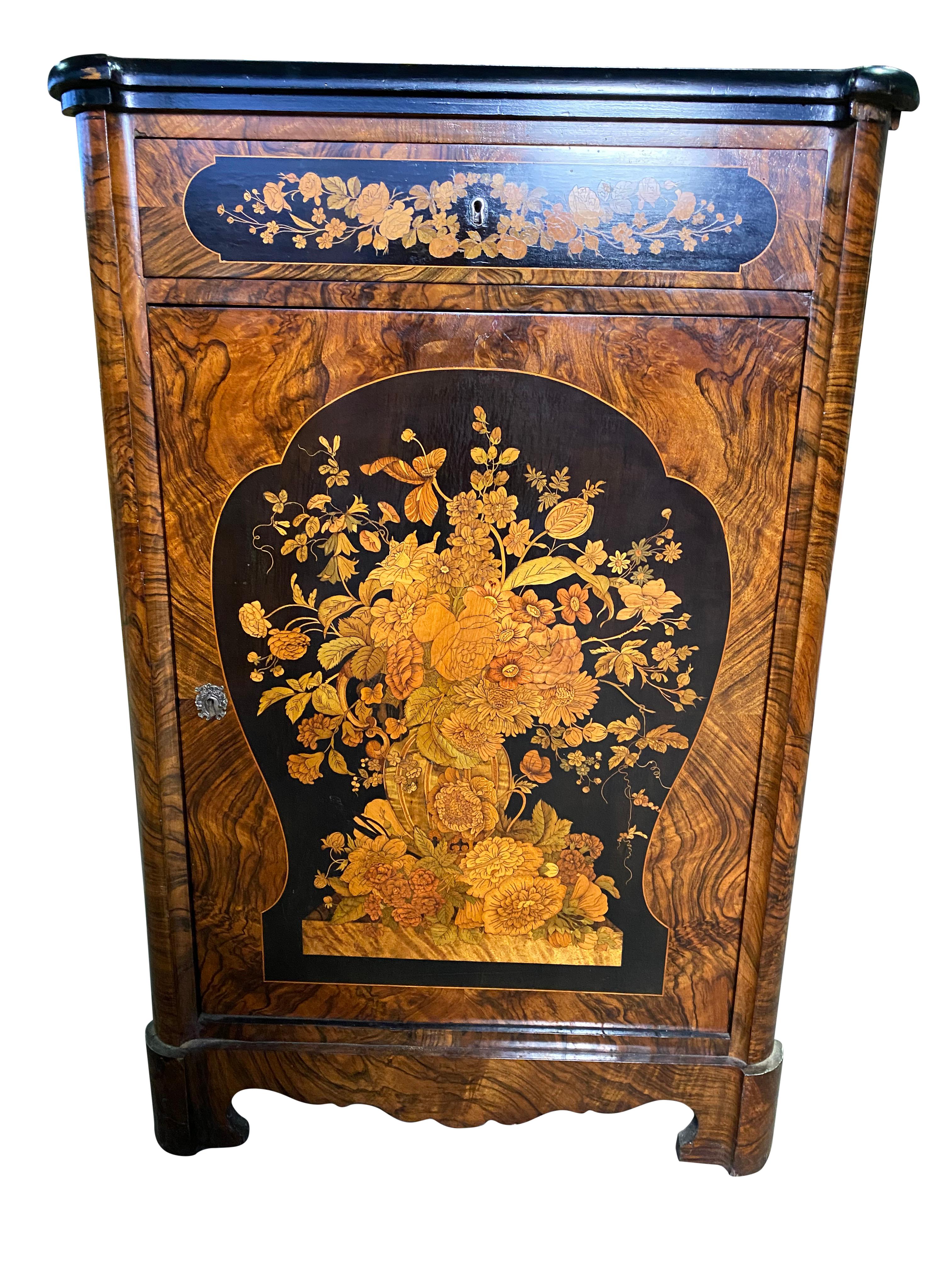 Beautiful 19th century Victorian cabinets with a stunning floral design covering the exterior walnut and satin wood marquetry inlay. Door with lock and key mechanism opens up to a spacious interior as well for a drawer at the top as