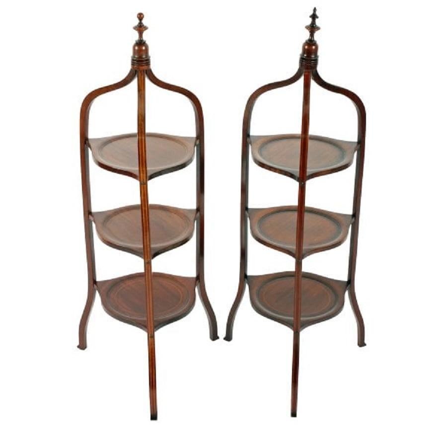 An almost pair of late 19th century Victorian inlaid mahogany étagères.

The étagères have three tiers of inlaid dish centre shelves that are supported by three shaped legs.

The top of both étagères have a turned mahogany finial.

The